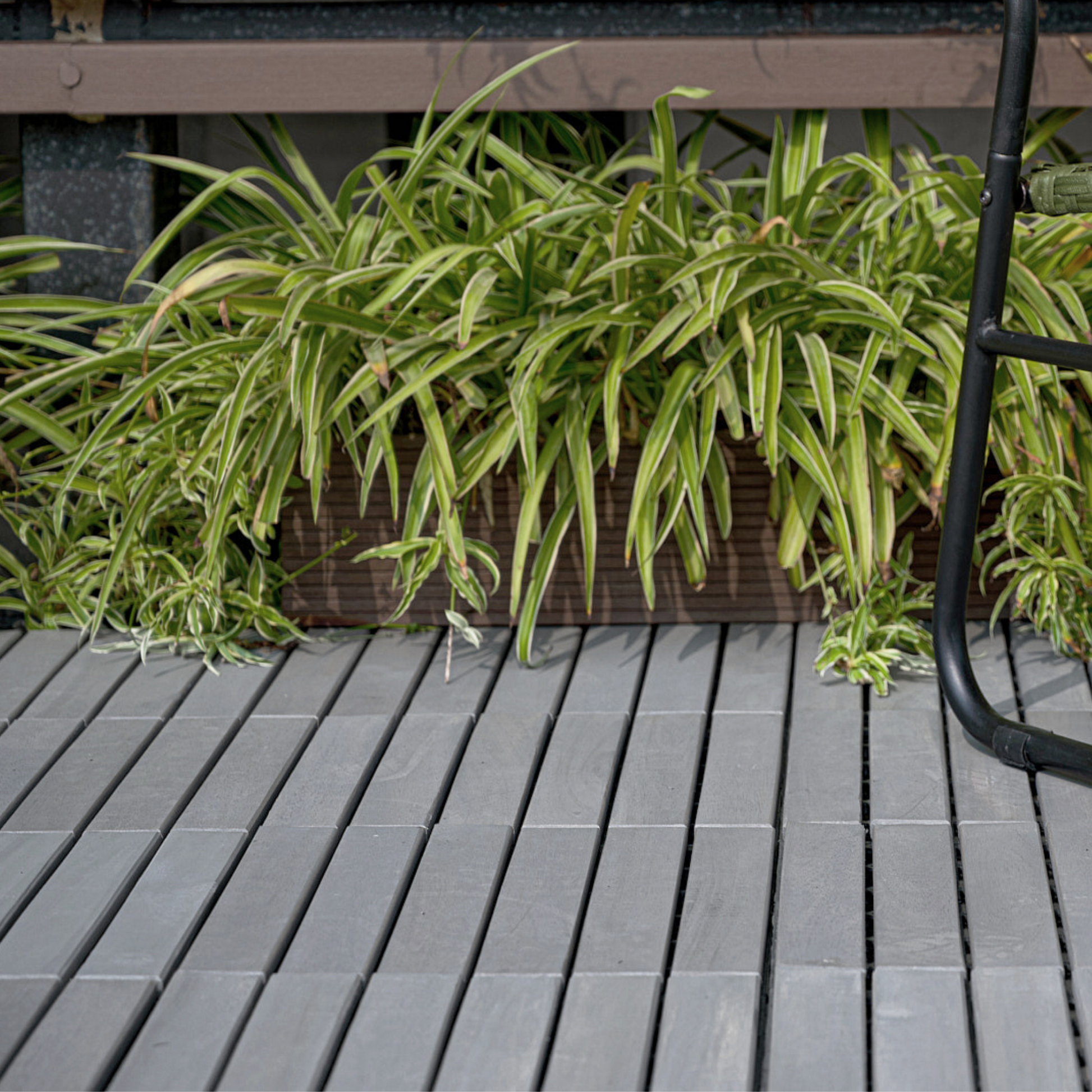 Grey composite deck tiles with textured surface suitable for outdoor patios