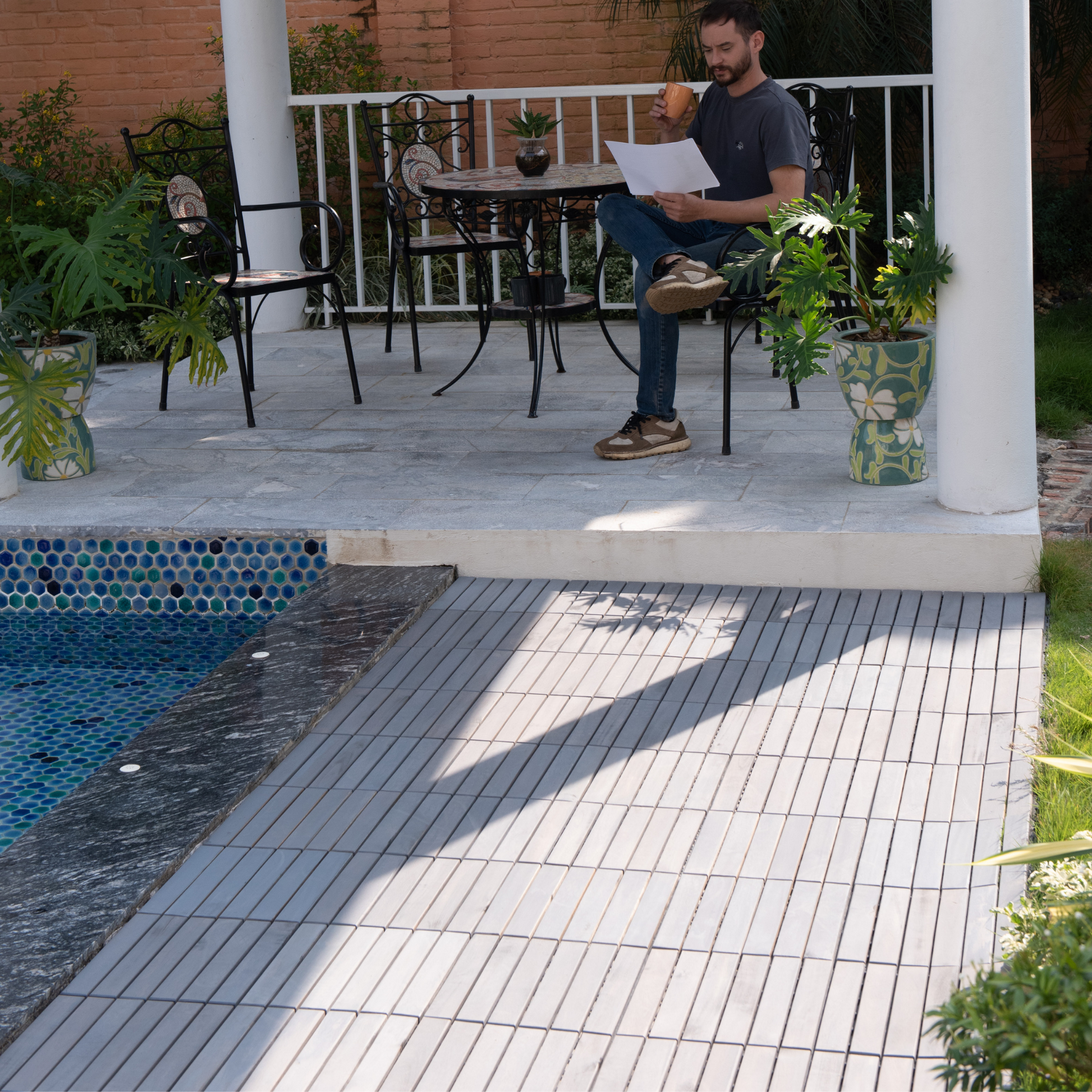 Mosaic accent chair with ornate scrollwork and tiled seat perfect for outdoor patios