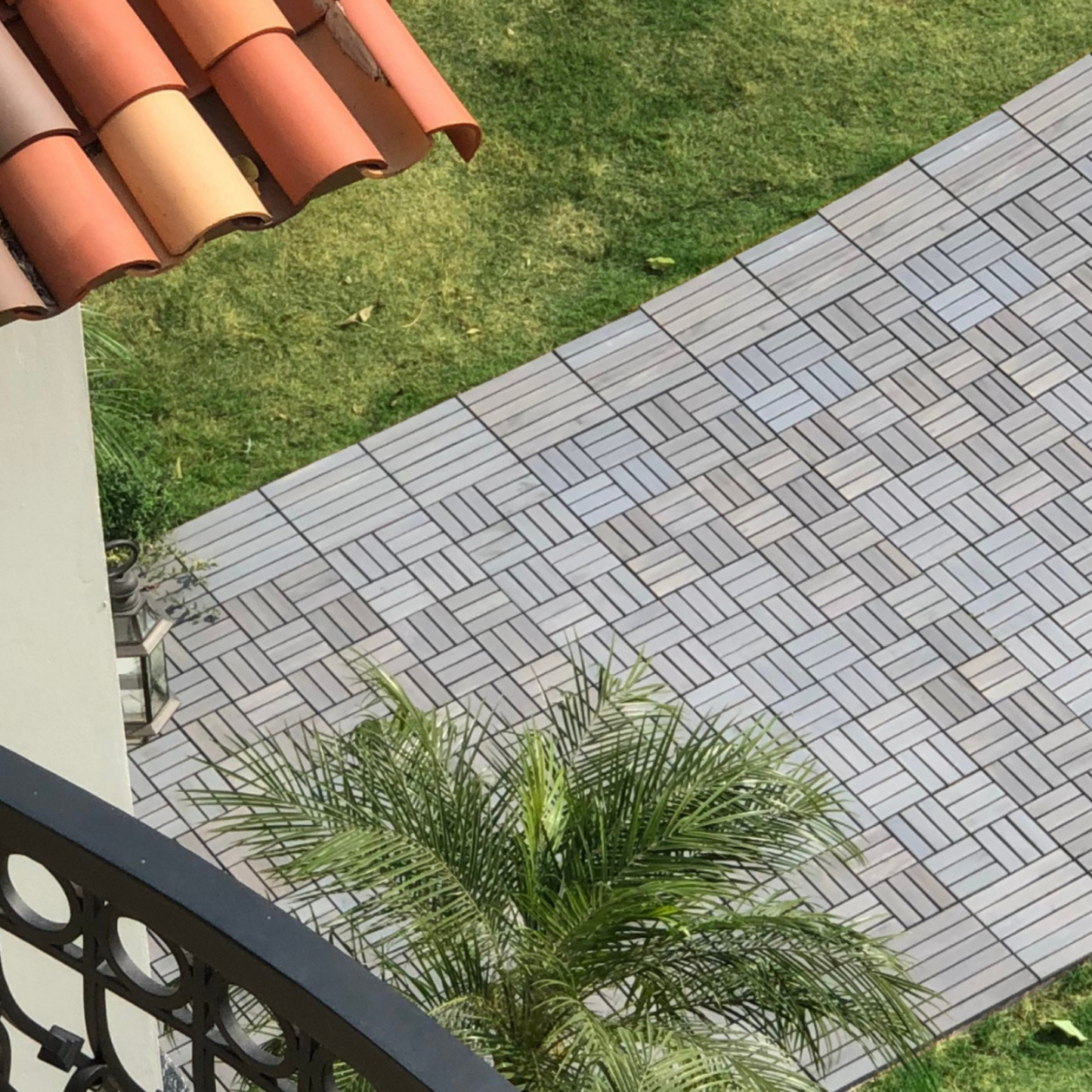 Contemporary interlocking deck tiles in light gray create a modern patio floor