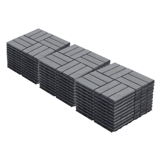 Stacks of grey composite deck tiles laid in a herringbone pattern for outdoor flooring