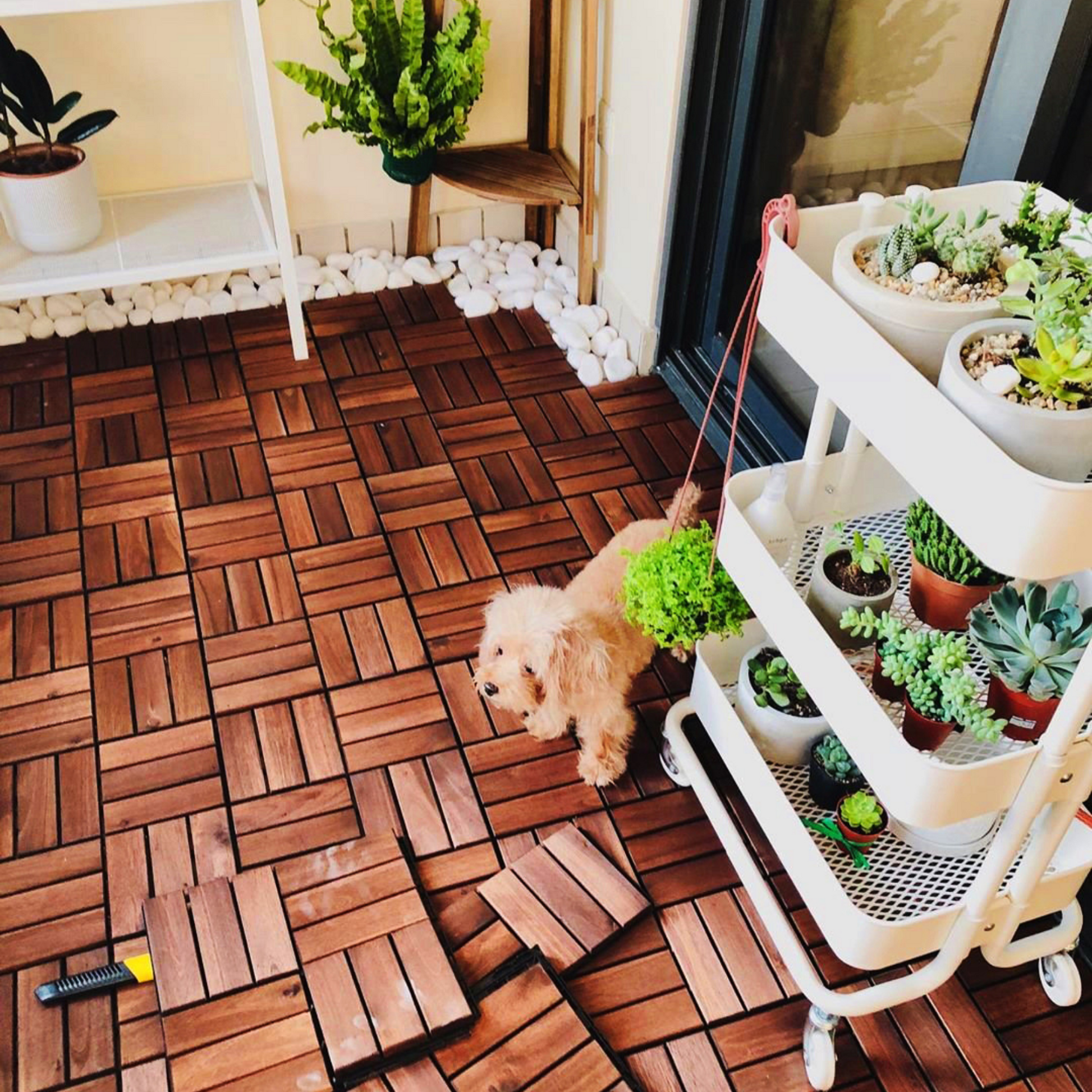 Rich brown hardwood deck tiles with intricate parquet pattern laid outdoors on a patio