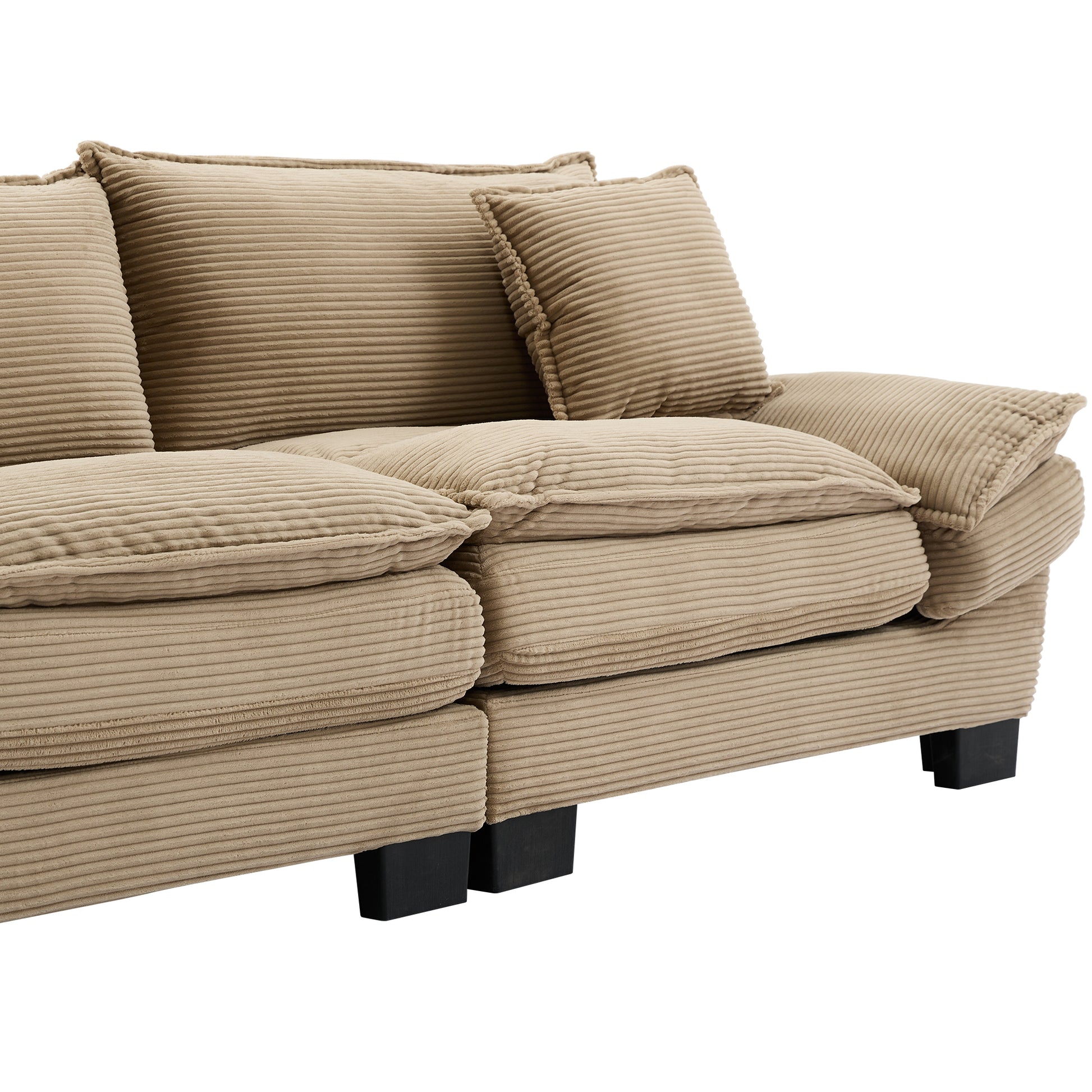 Closeup of a beige corduroy sectional sofa with plush cushions and modern black legs