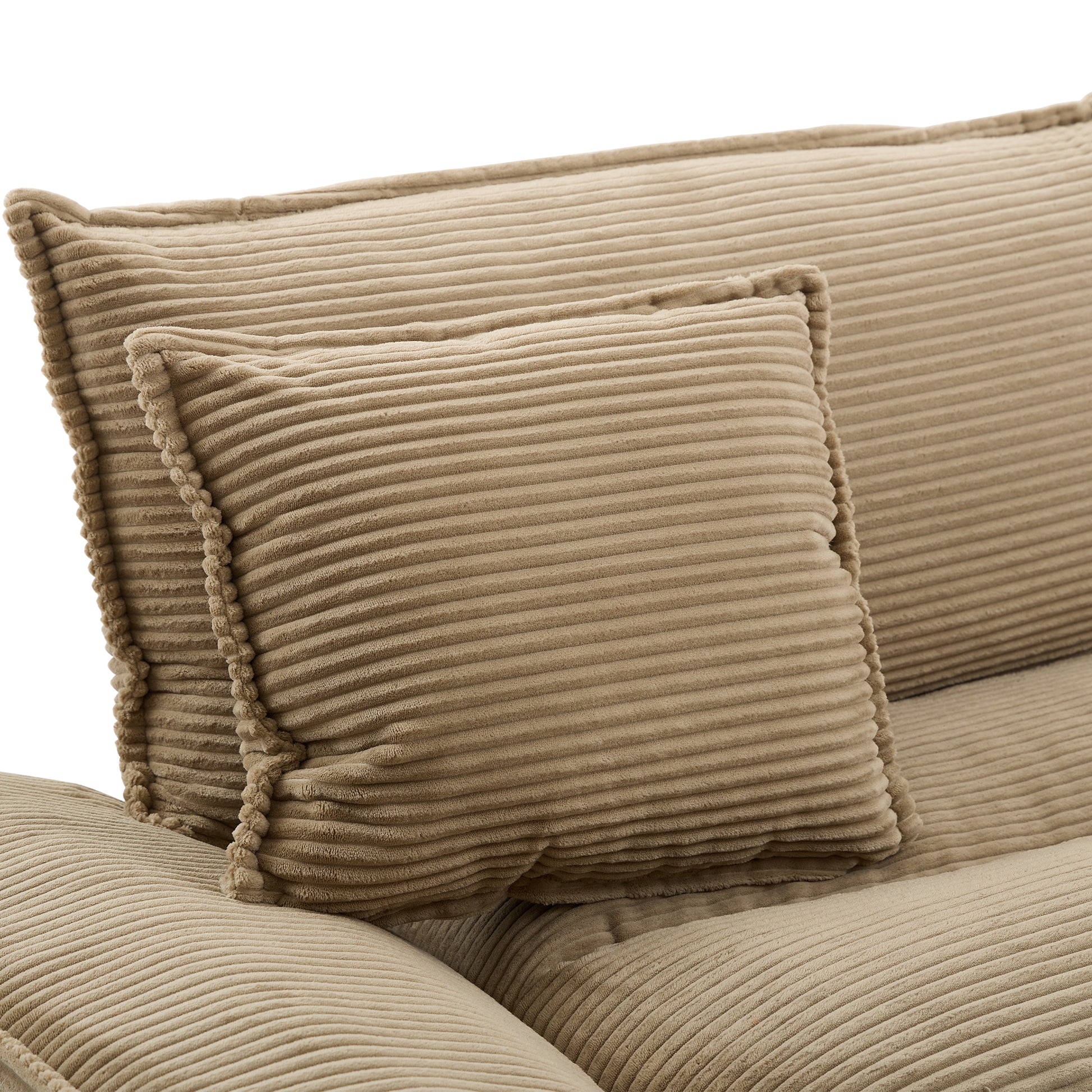 Close up of textured beige corduroy sofa cushions with fluffy trim