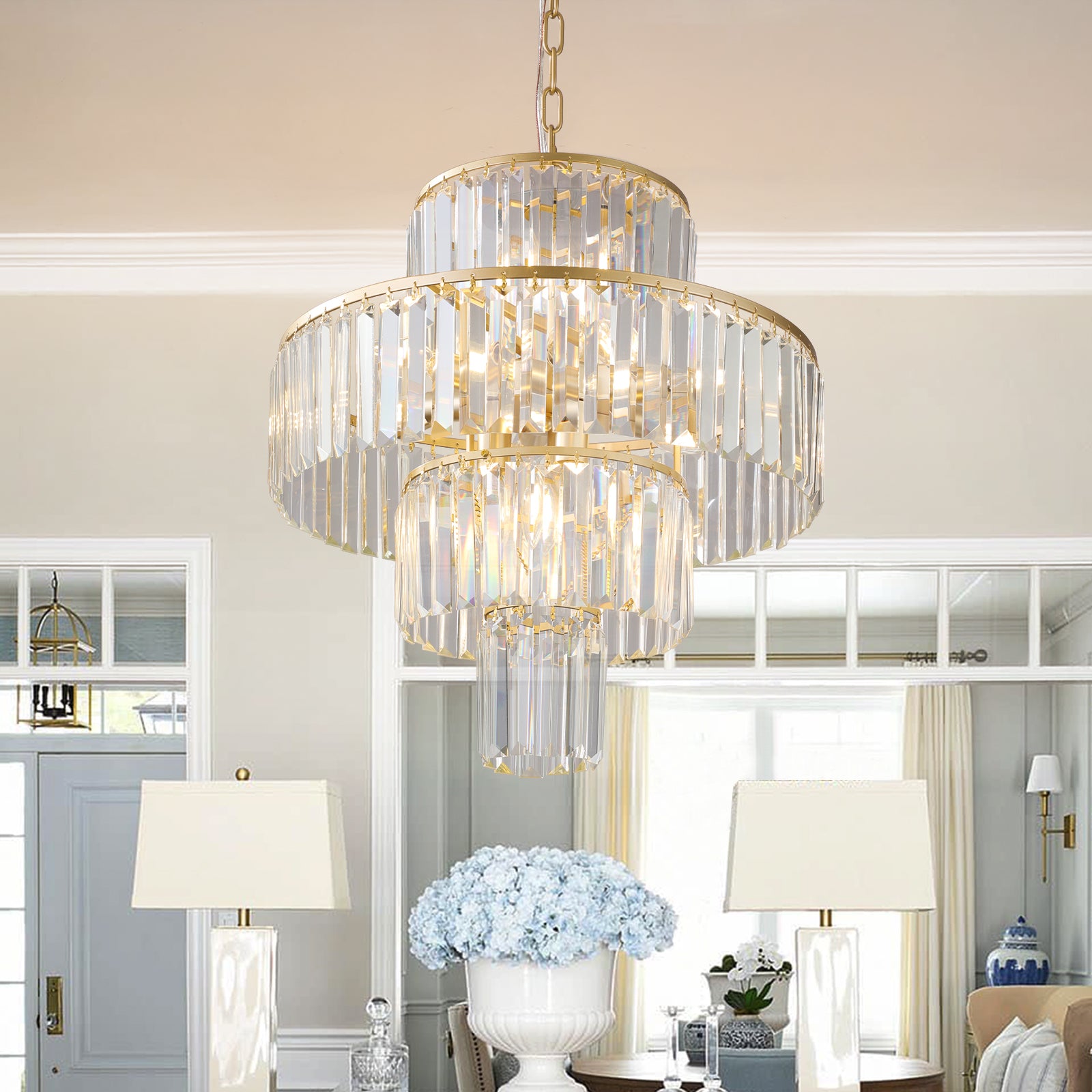 Threetier gold chandelier with faceted crystal prisms and elegant silhouette