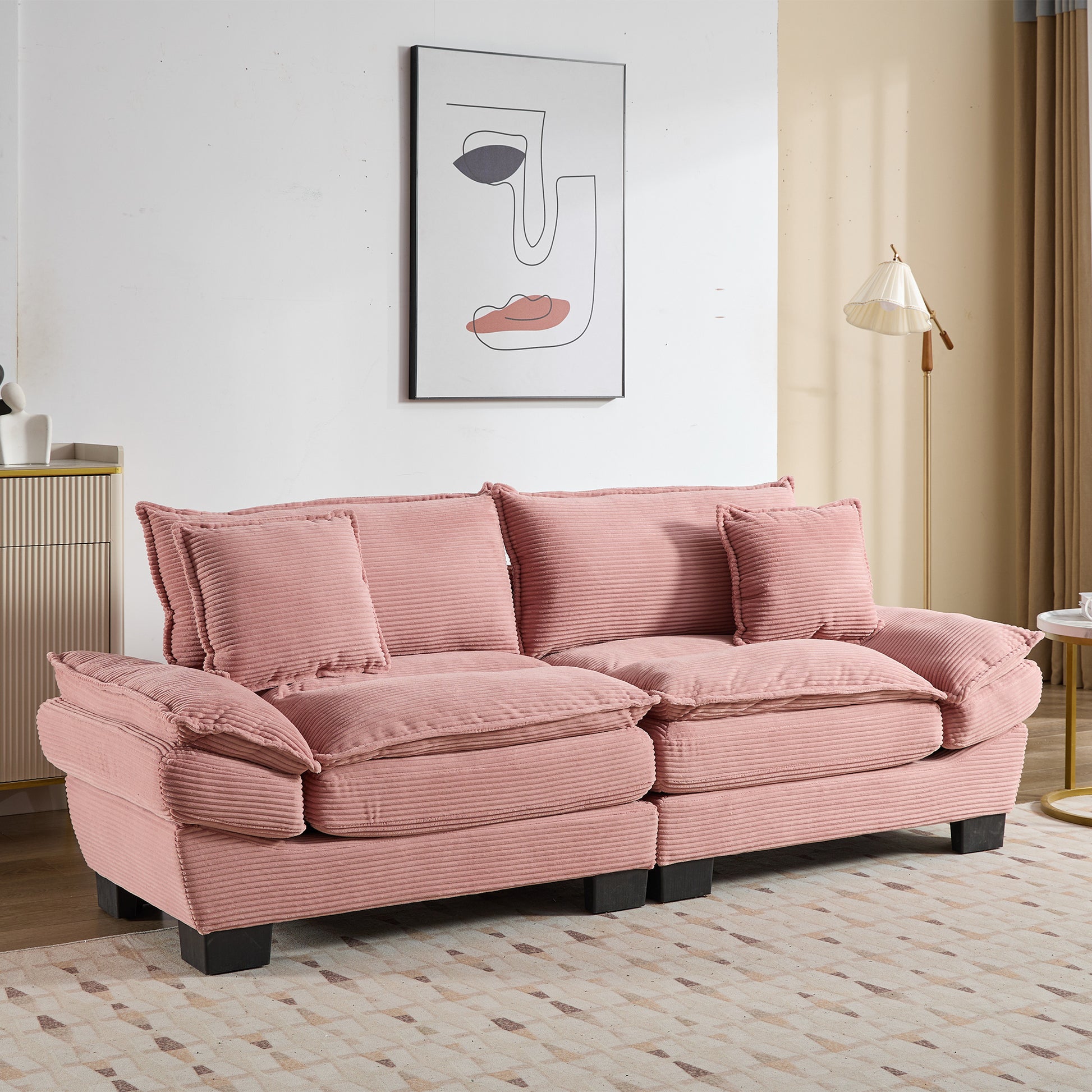 Plush pink corduroy sofa with deep cushions and accent pillows perfect for a cozy living room