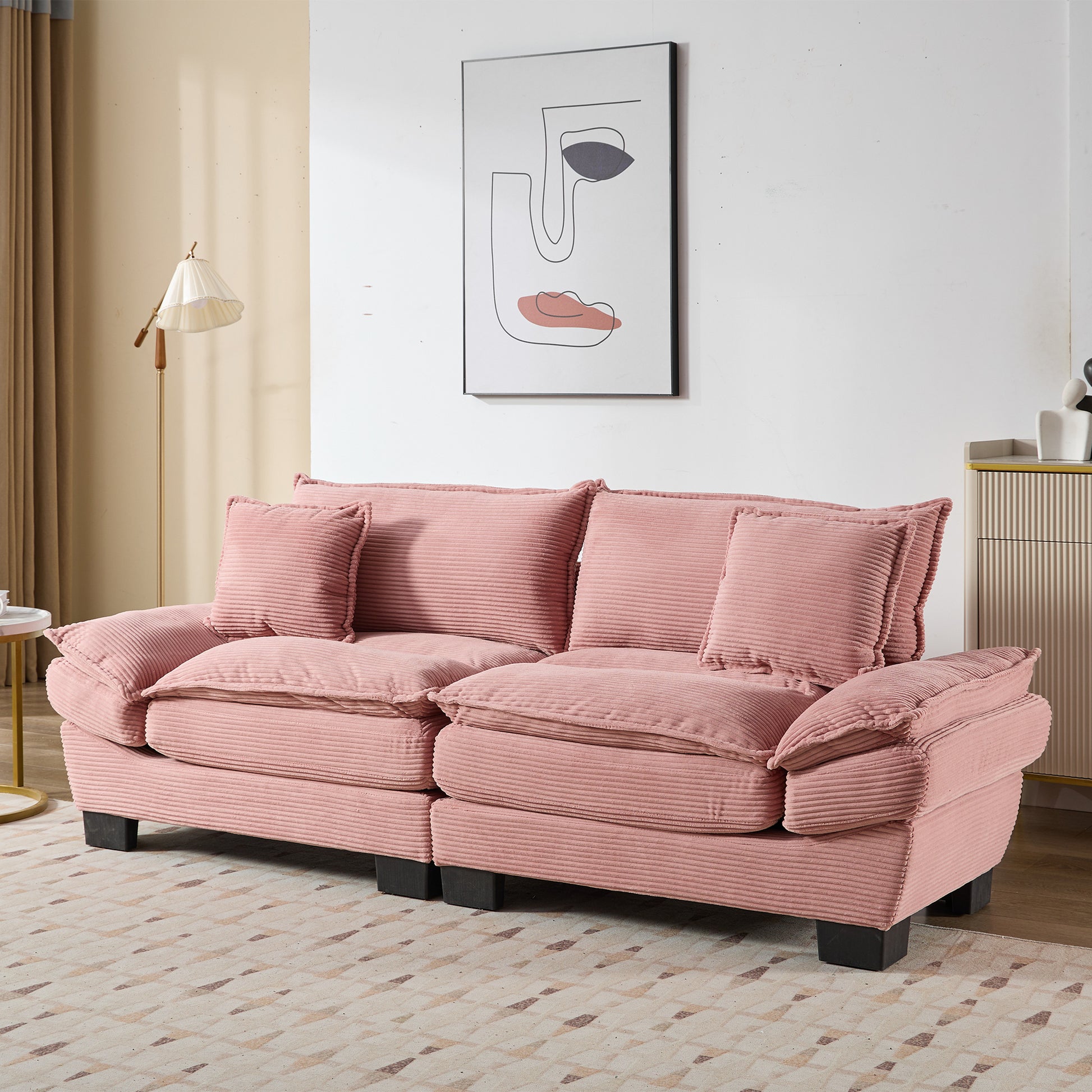 Plush pink corduroy sofa with deep cushions and accent pillows for a cozy living room