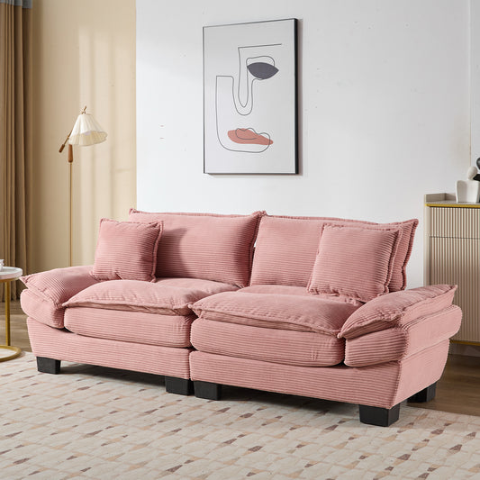 Plush pink corduroy sofa with deep cushions and accent pillows for a cozy living room