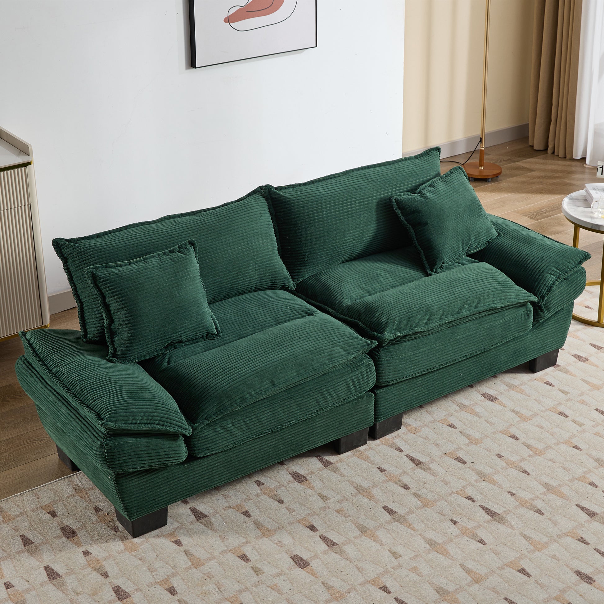 Deep green corduroy sectional sofa with plush cushions and throw pillows