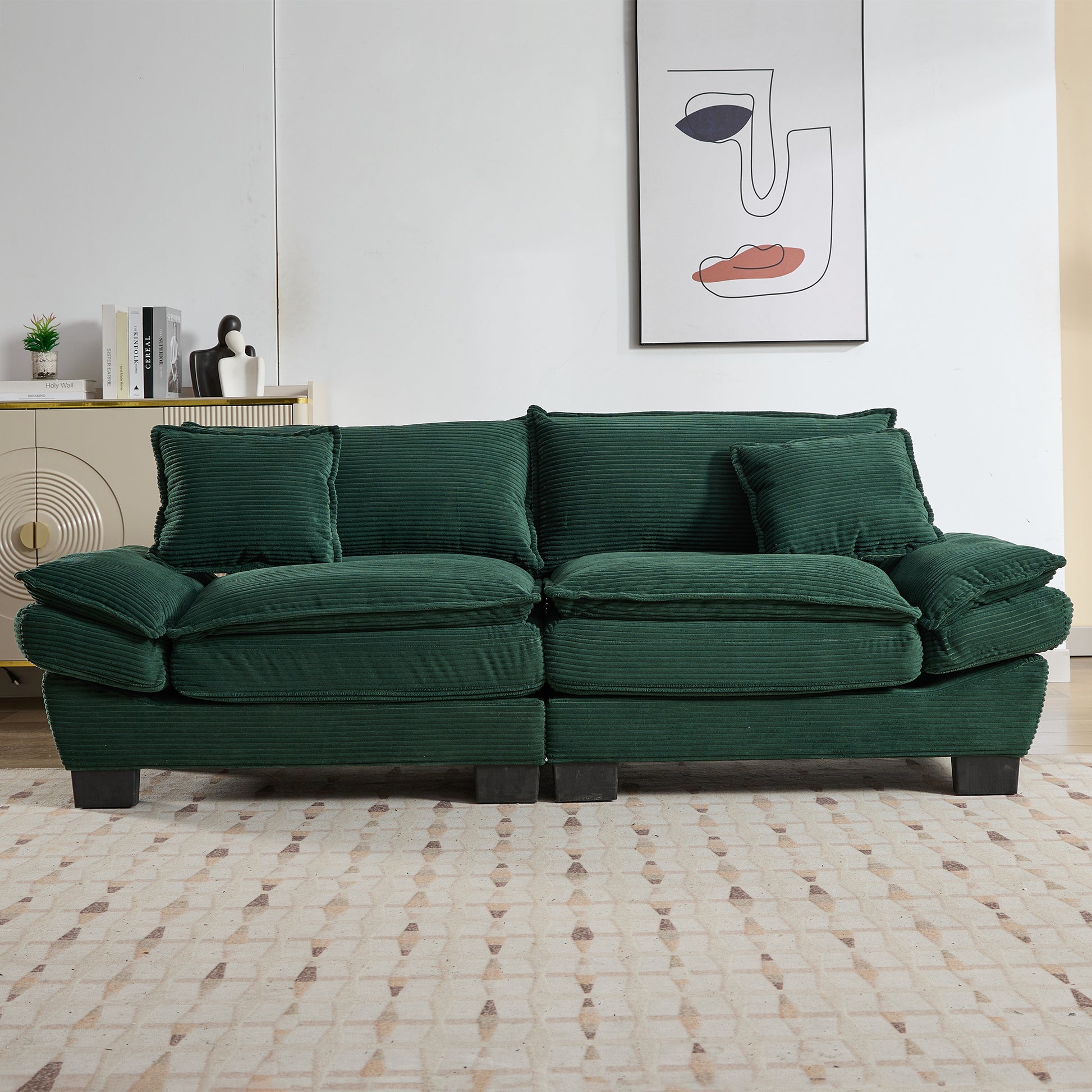 Plush forest green corduroy sofa with ample seating and accent pillows for a cozy living room