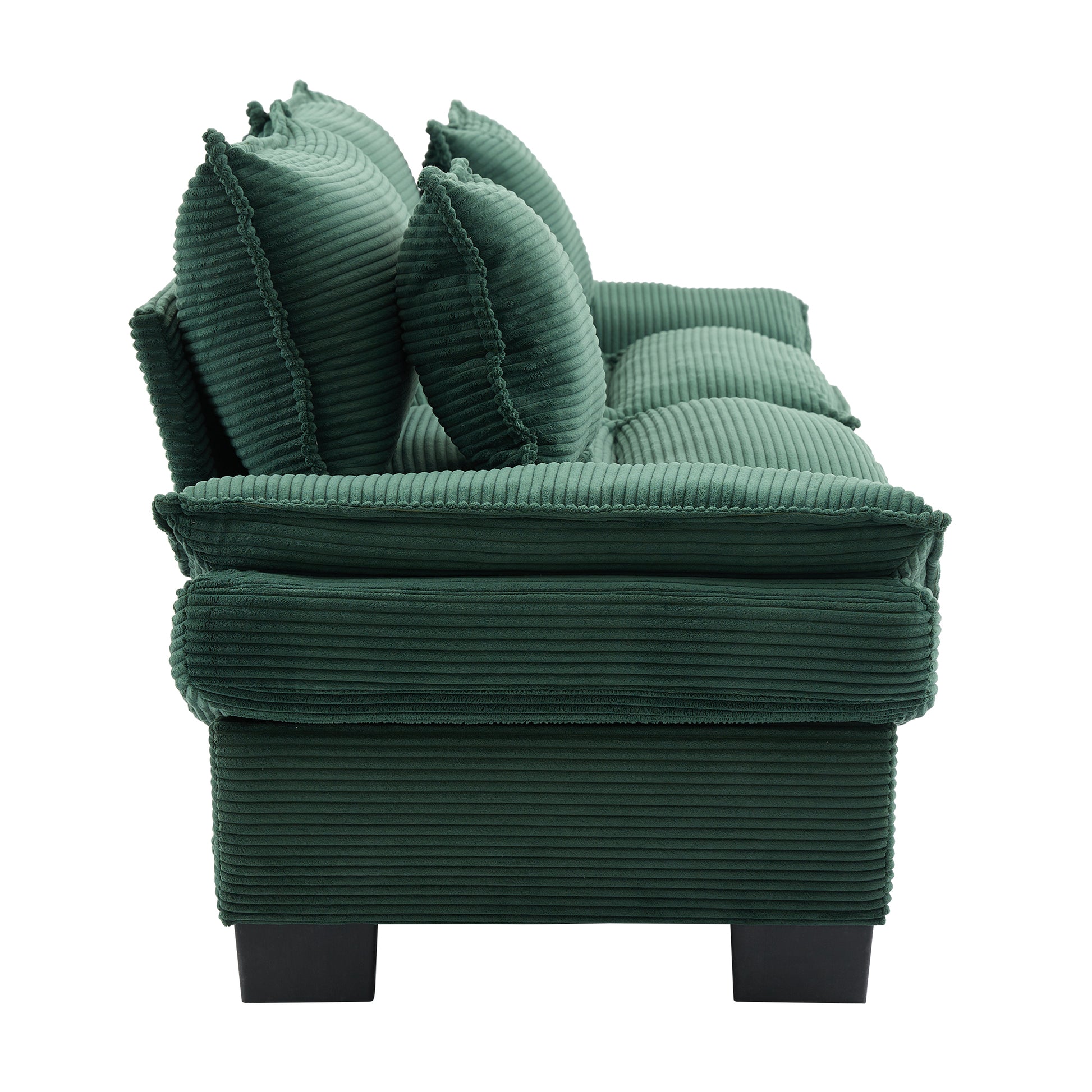 Plush emerald green corduroy sofa with deep tufted cushions perfect for a cozy living room