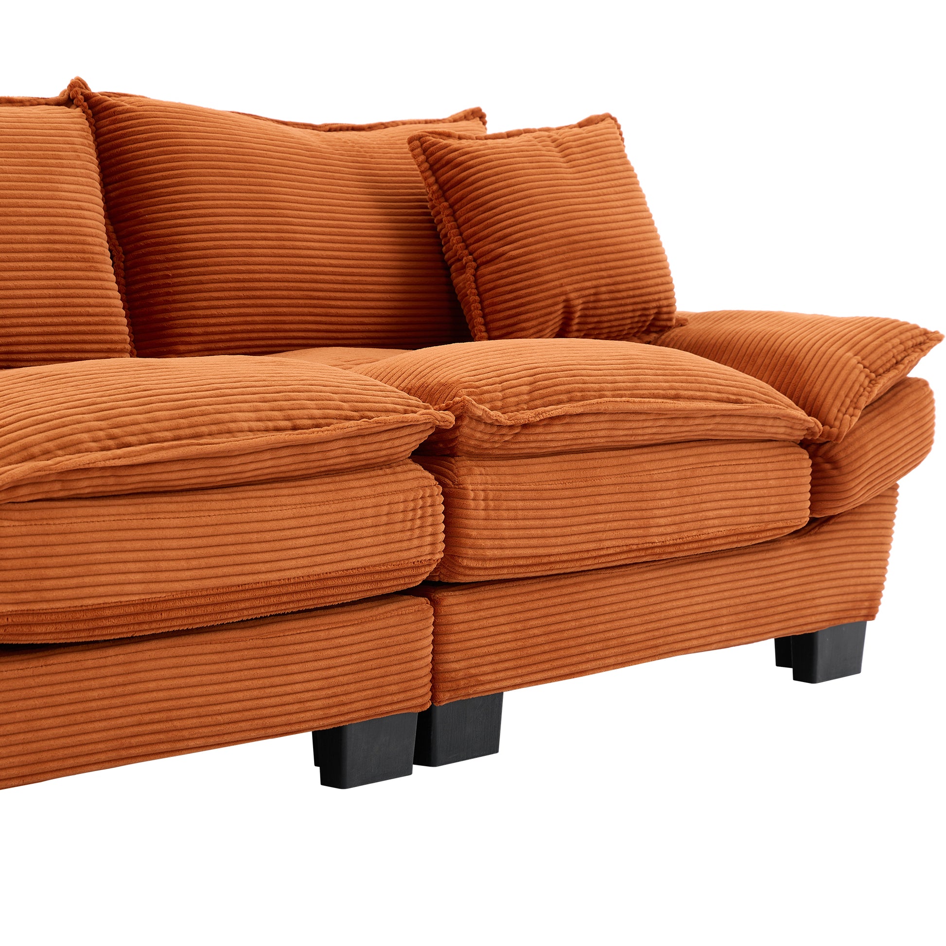 Closeup of plush orange corduroy sofa cushions with textured horizontal ridges modern design