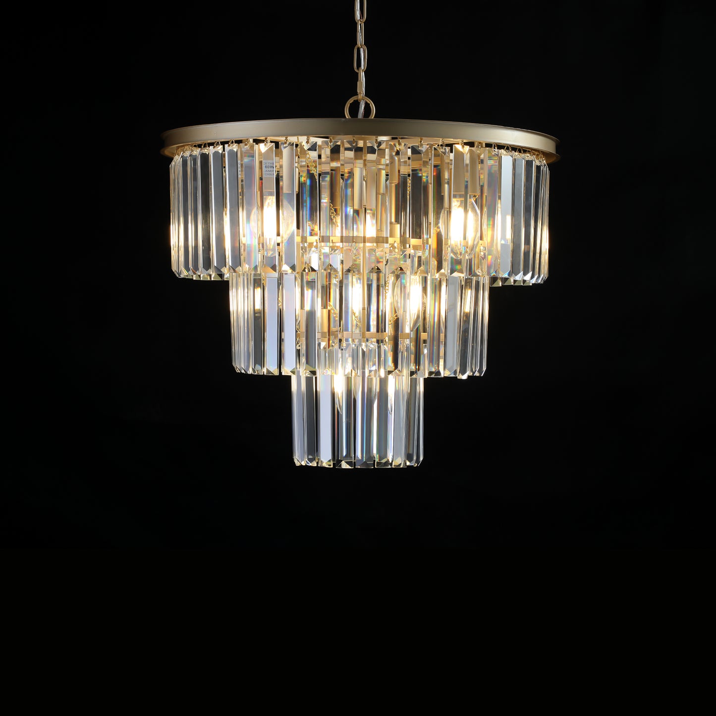 Tiered crystal chandelier with gold metal accents and warm LED bulbs