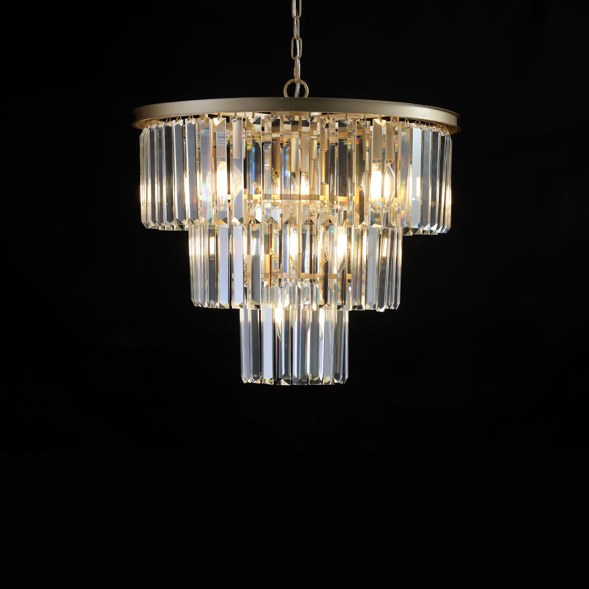 Tiered crystal chandelier with gold metal accents and warm LED bulbs