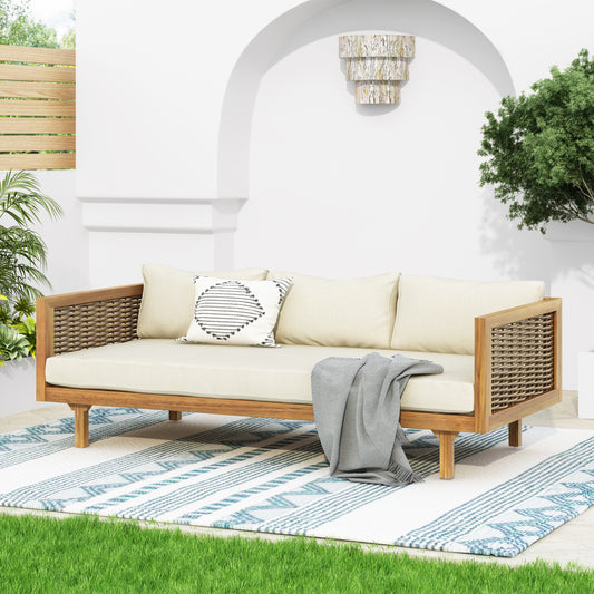 Modern outdoor sofa with woven rattan arms and cream cushions perfect for patio relaxation