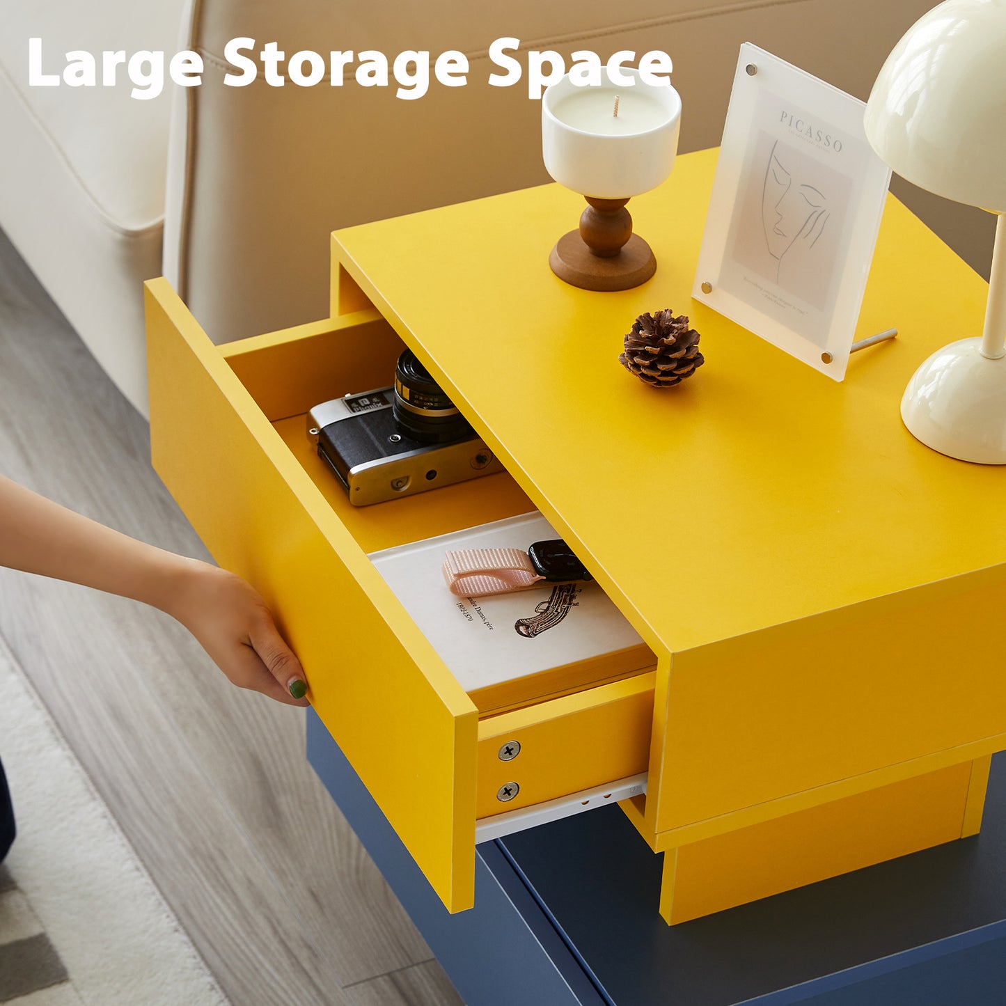 Yellow modern nightstand with open drawer revealing camera