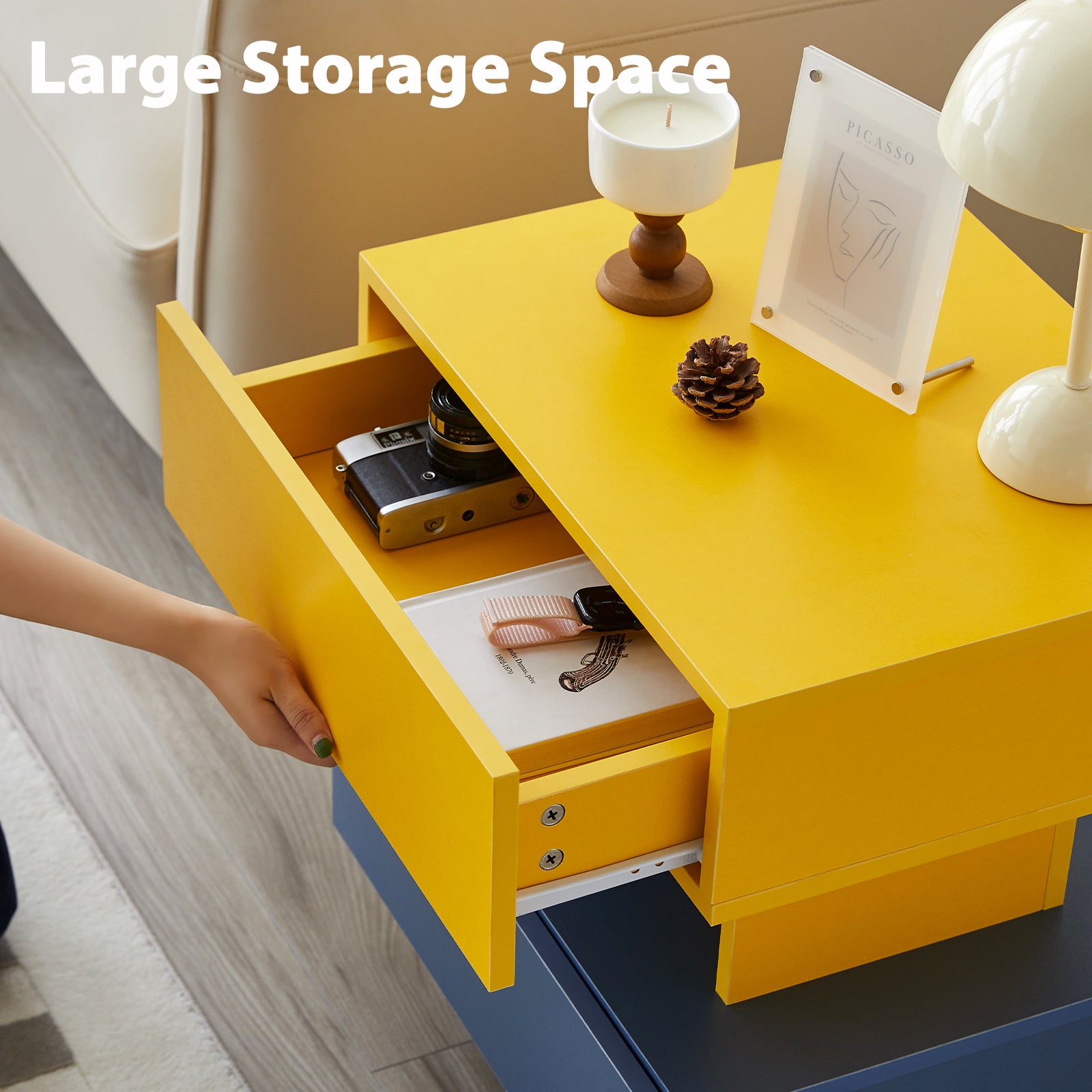 Yellow modern nightstand with open drawer revealing camera