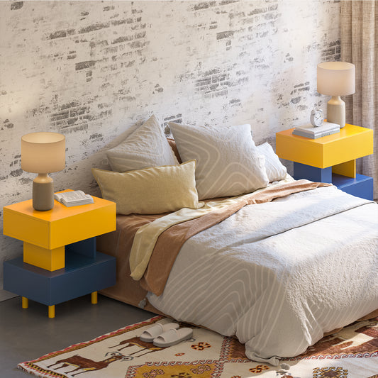 Modern yellow and blue geometric bedside table with a lamp and books