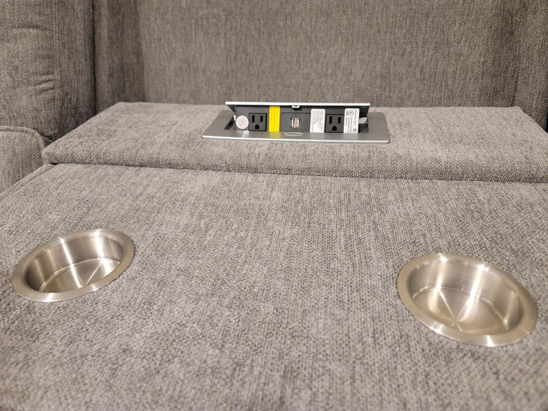 Gray fabric couch with popup power outlet featuring USB ports and AC outlet