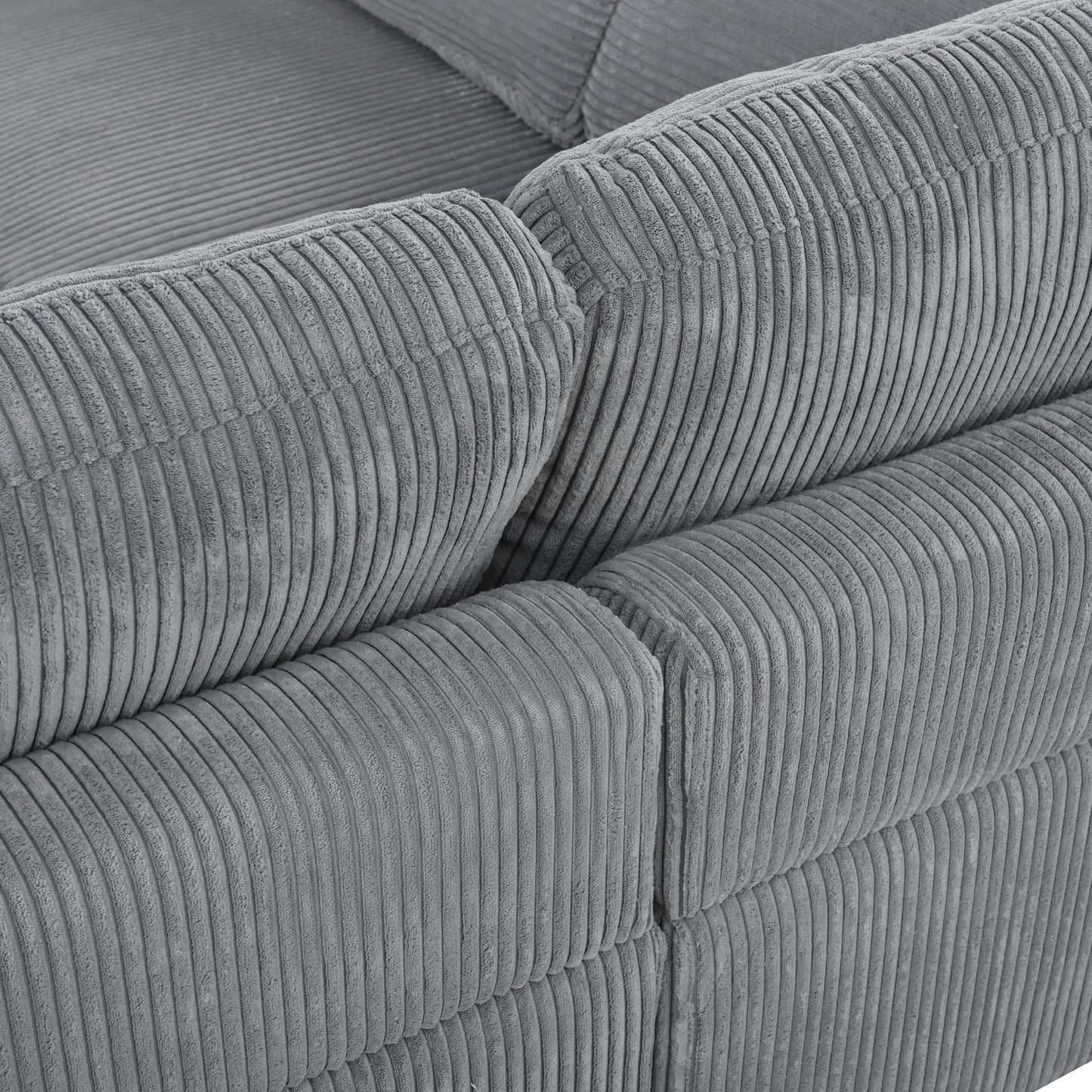 Closeup of a plush grey corduroy sofa section highlighting its textured fabric and comfortable seating