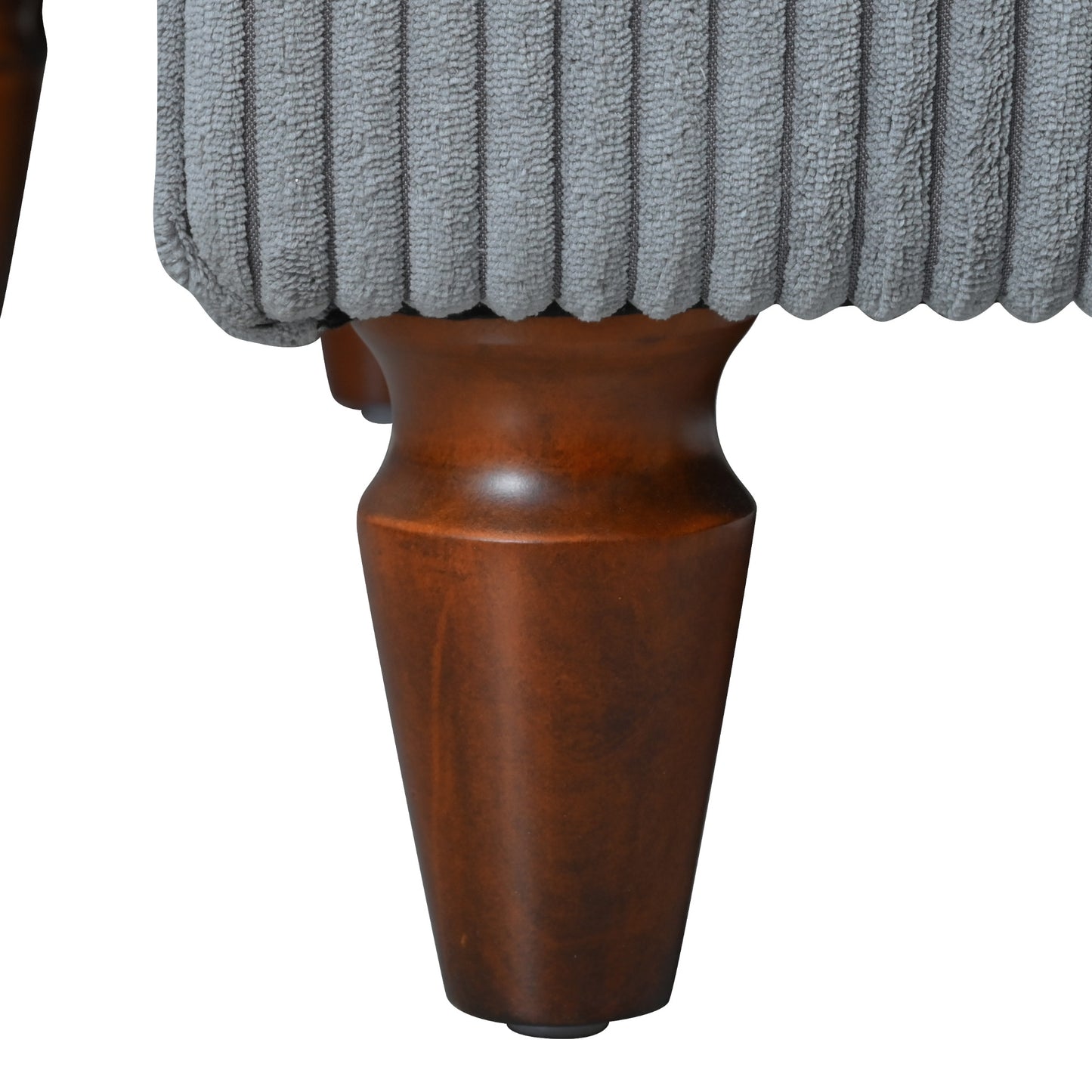 Closeup of grey corduroy ottoman fabric with ornate wooden legs