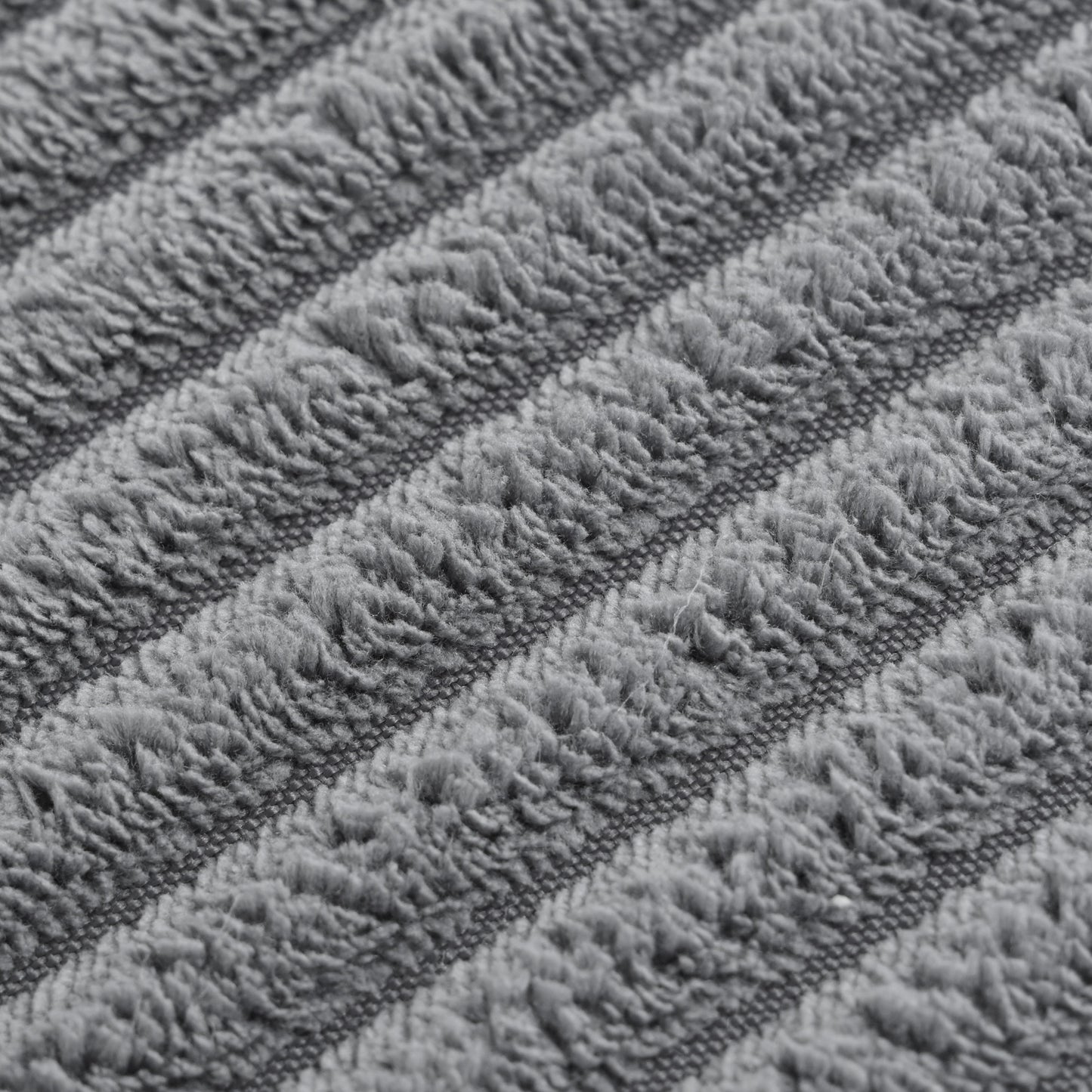 Closeup of plush grey chenille fabric with diagonal ribbed texture