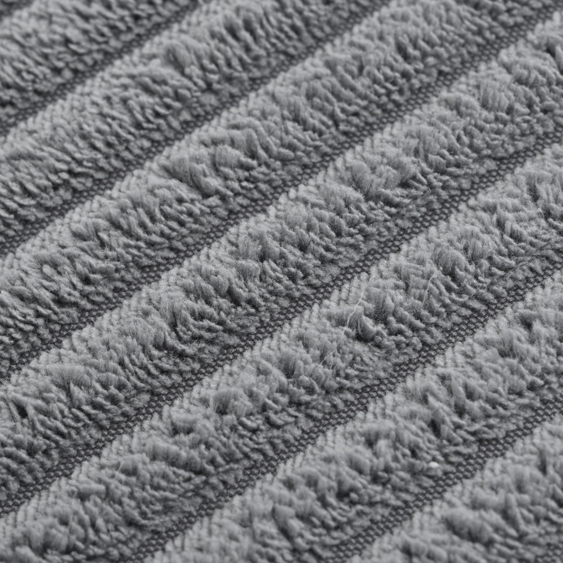 Closeup of plush grey chenille fabric with diagonal ribbed texture