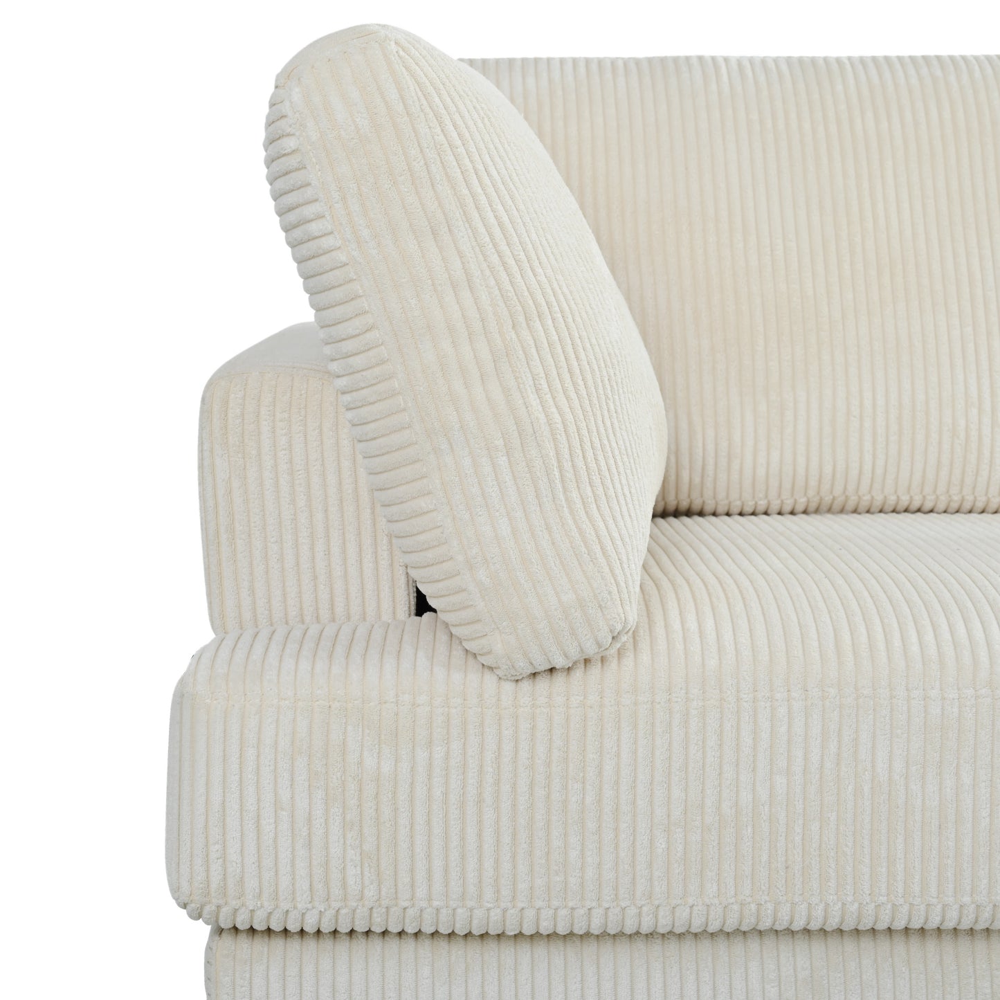 Closeup of a plush ivory corduroy sofa armrest with a matching cushion