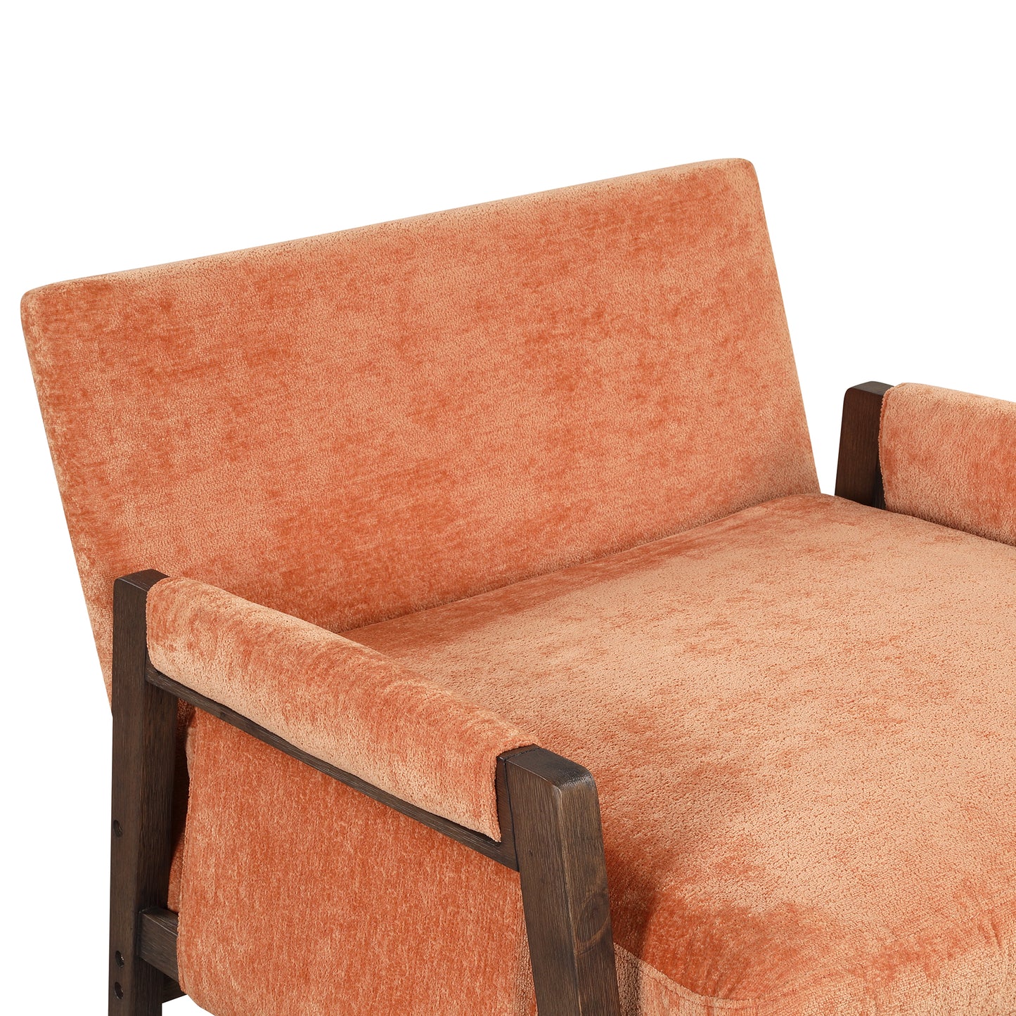 Plush coral velvet armchair with dark wood frame detail for a modern living room