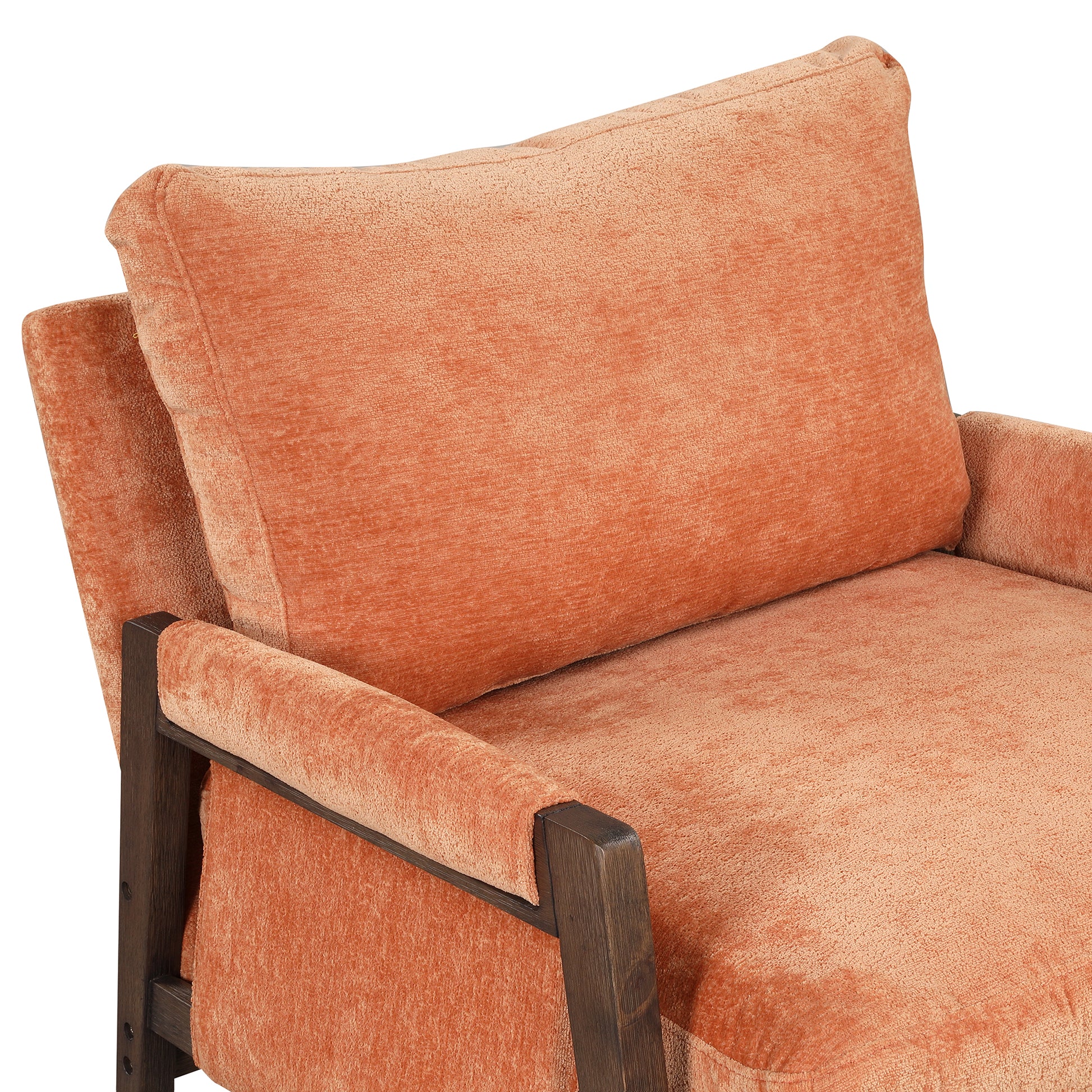 Closeup of an orange velvet accent chair with a dark wood frame