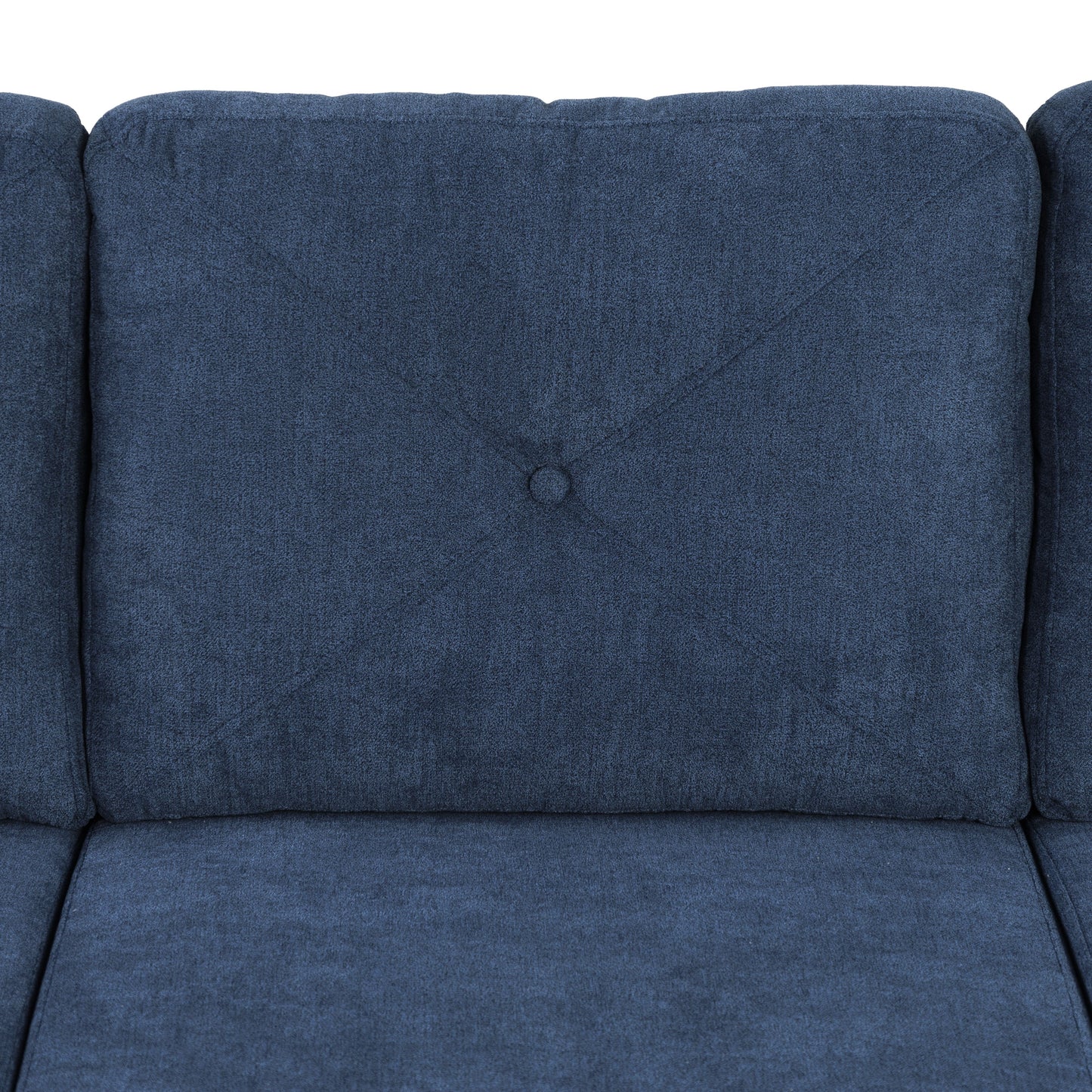 Closeup of a navy blue fabric sofa cushion with diamond stitching and a central button