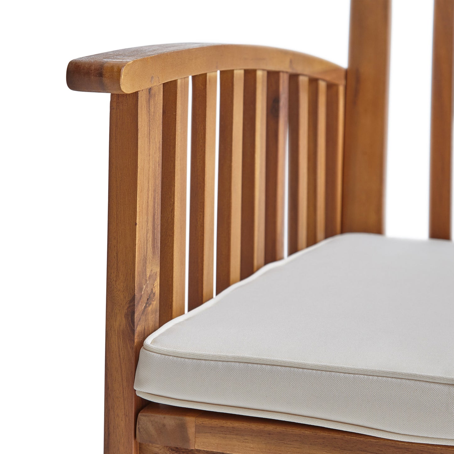 Closeup of a wooden outdoor chair arm with a white cushion
