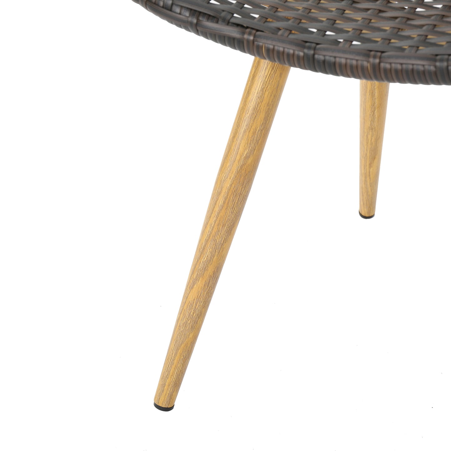 Brown wicker round table edge with three wooden tapered legs