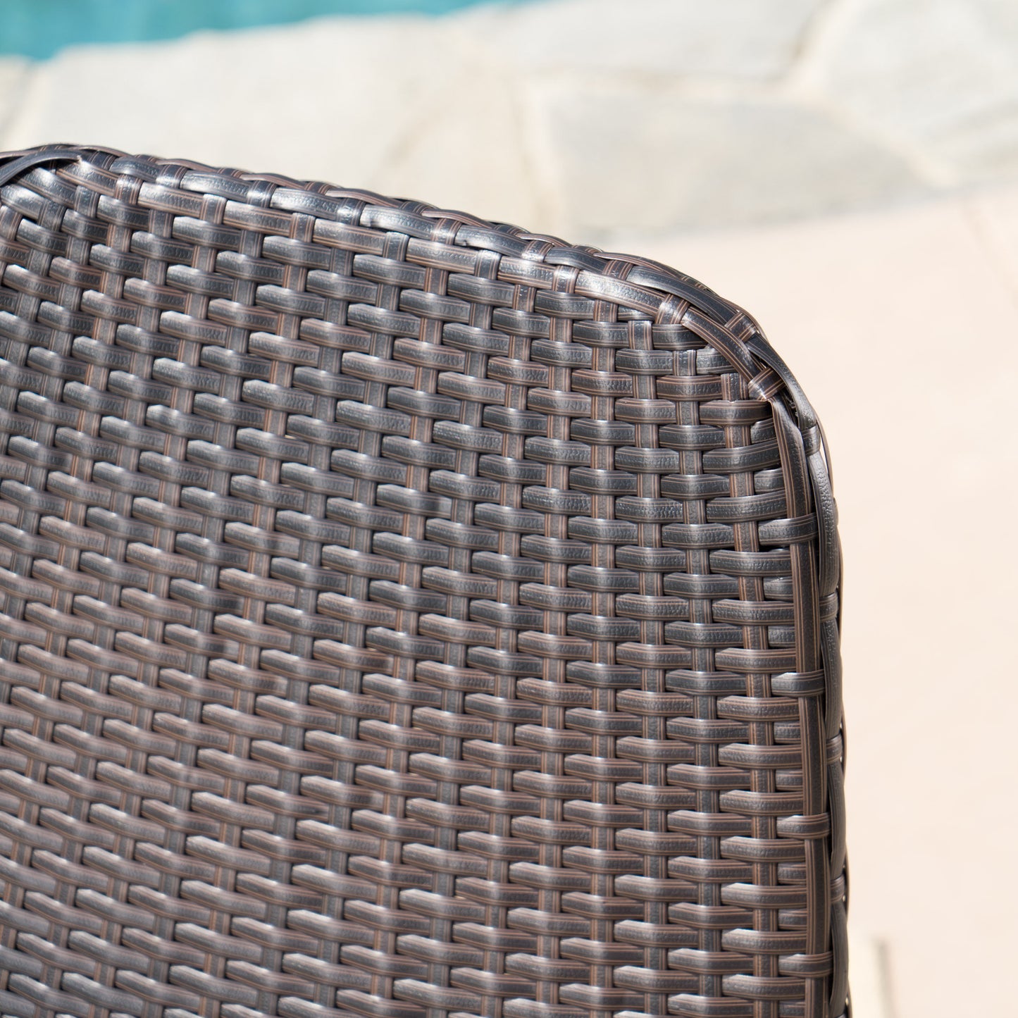 Dark brown wicker chair back detail with woven texture