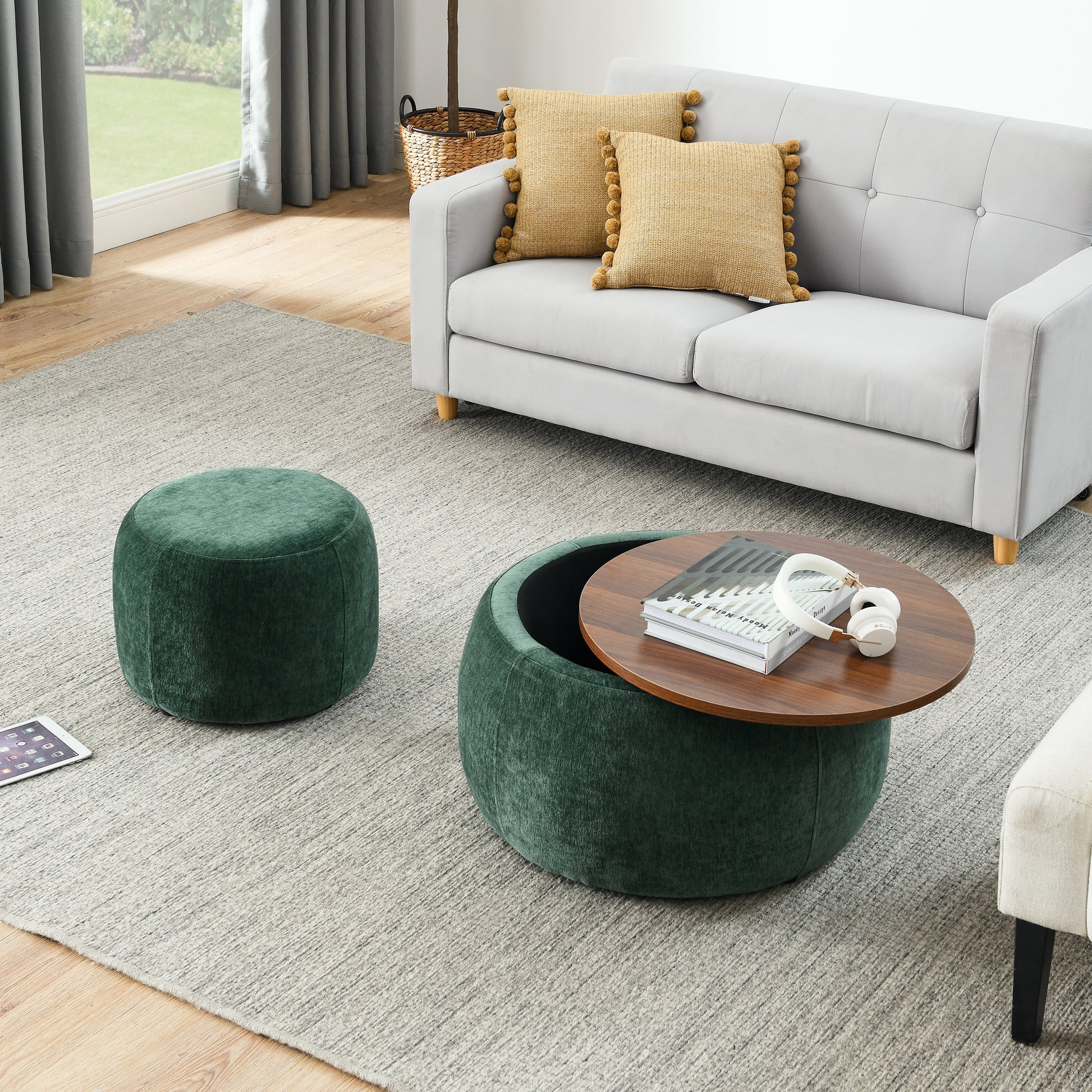 Dark green velvet round storage ottoman with lifttop coffee table and headphones