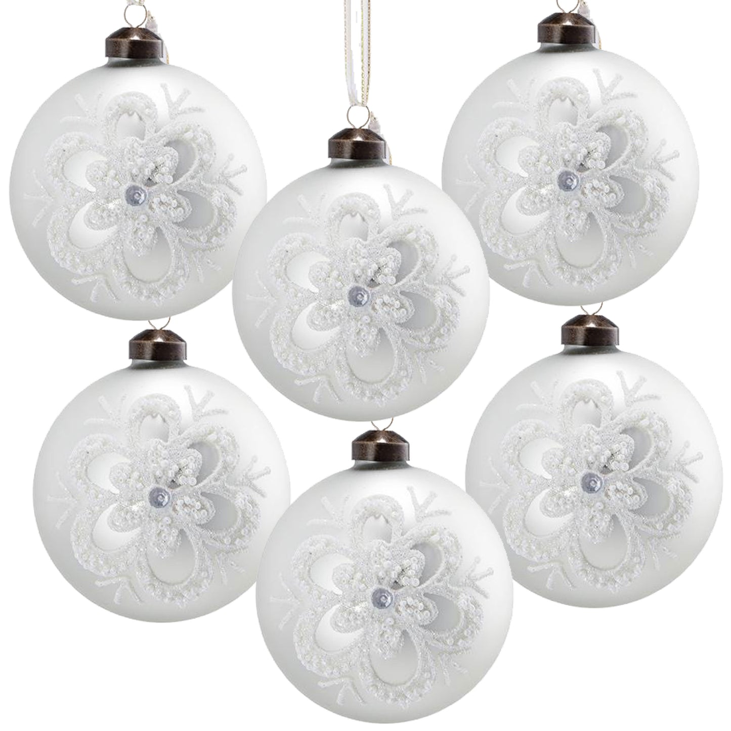 Set of  frosted white glass Christmas ornaments with intricate snowflake designs and silver center gem