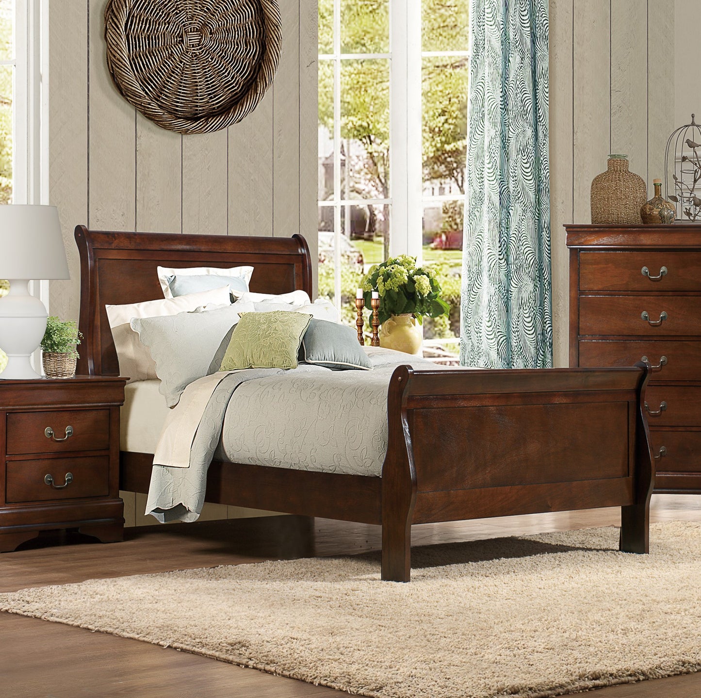 Dark wood sleigh bed with quilted bedding and decorative pillows