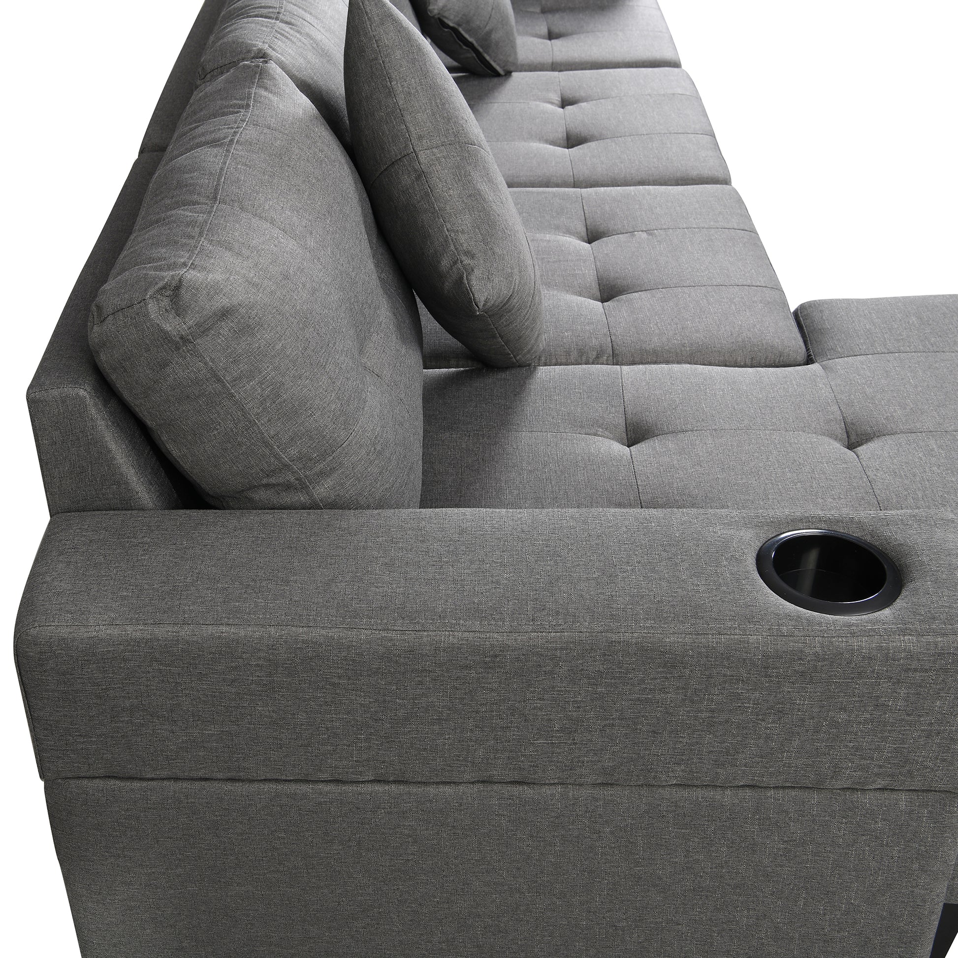 Grey fabric sectional sofa with tufted cushions and integrated cup holder