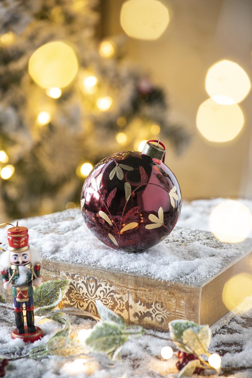Deep red glass Christmas ornament with gold leaf pattern