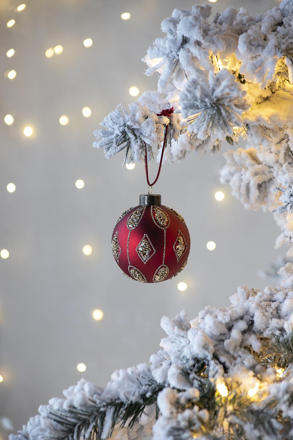 Red matte Christmas ornament with diamond pattern and glitter accents