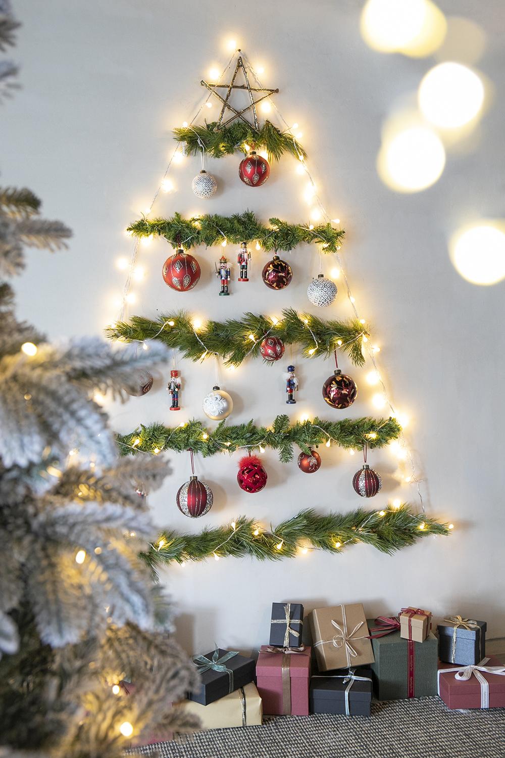 Wall Christmas tree with festive ornaments nutcracker figures and twinkling fairy lights