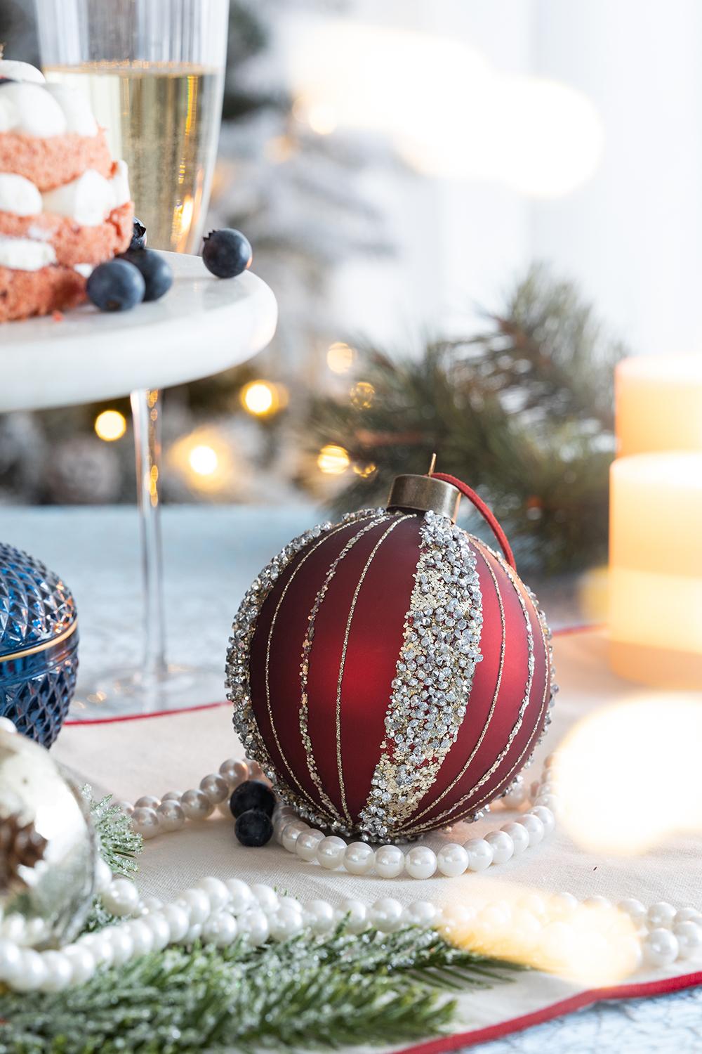 Red ribbed glass Christmas ornament with beaded trim and hanging loop
