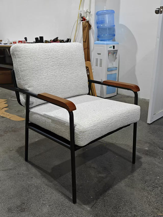 Textured light gray armchair with black metal frame and wooden armrests perfect for a modern living room
