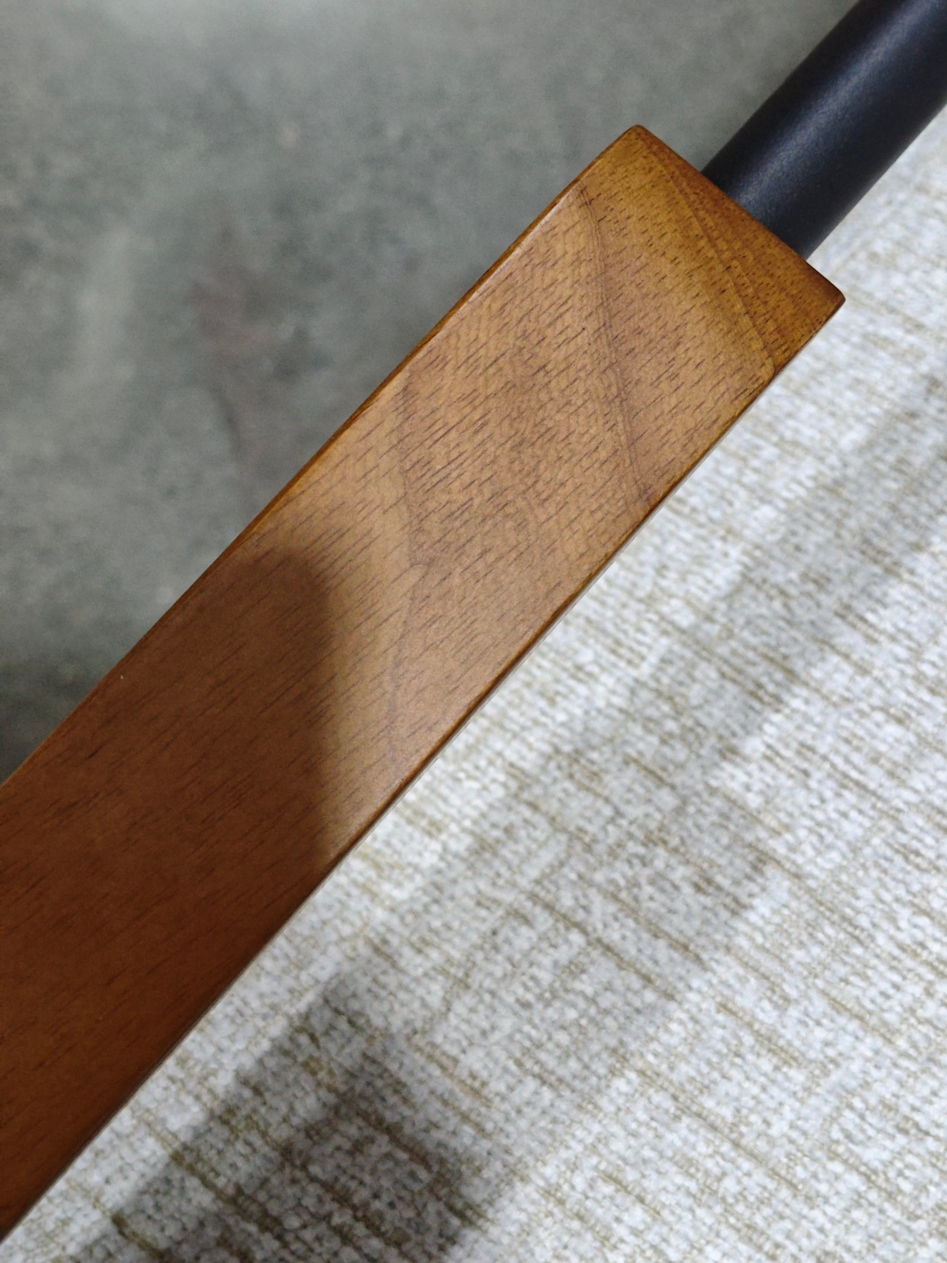 Closeup of a polished oak wood grain detail on a modern furniture piece