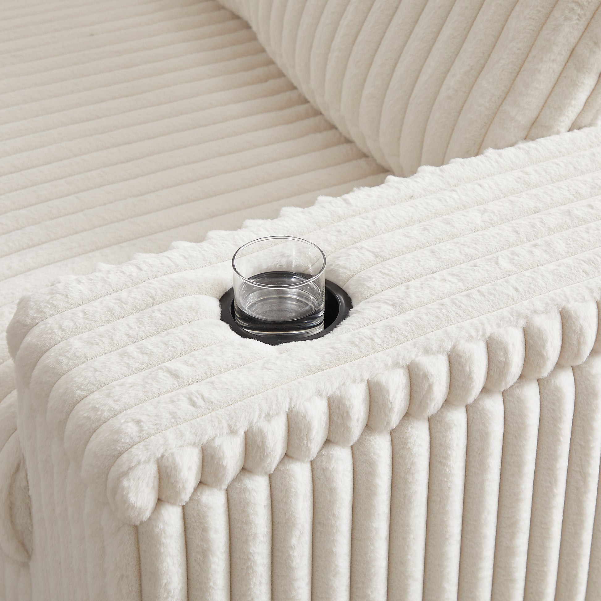 Cream corduroy armchair armrest with integrated cup holder and glass