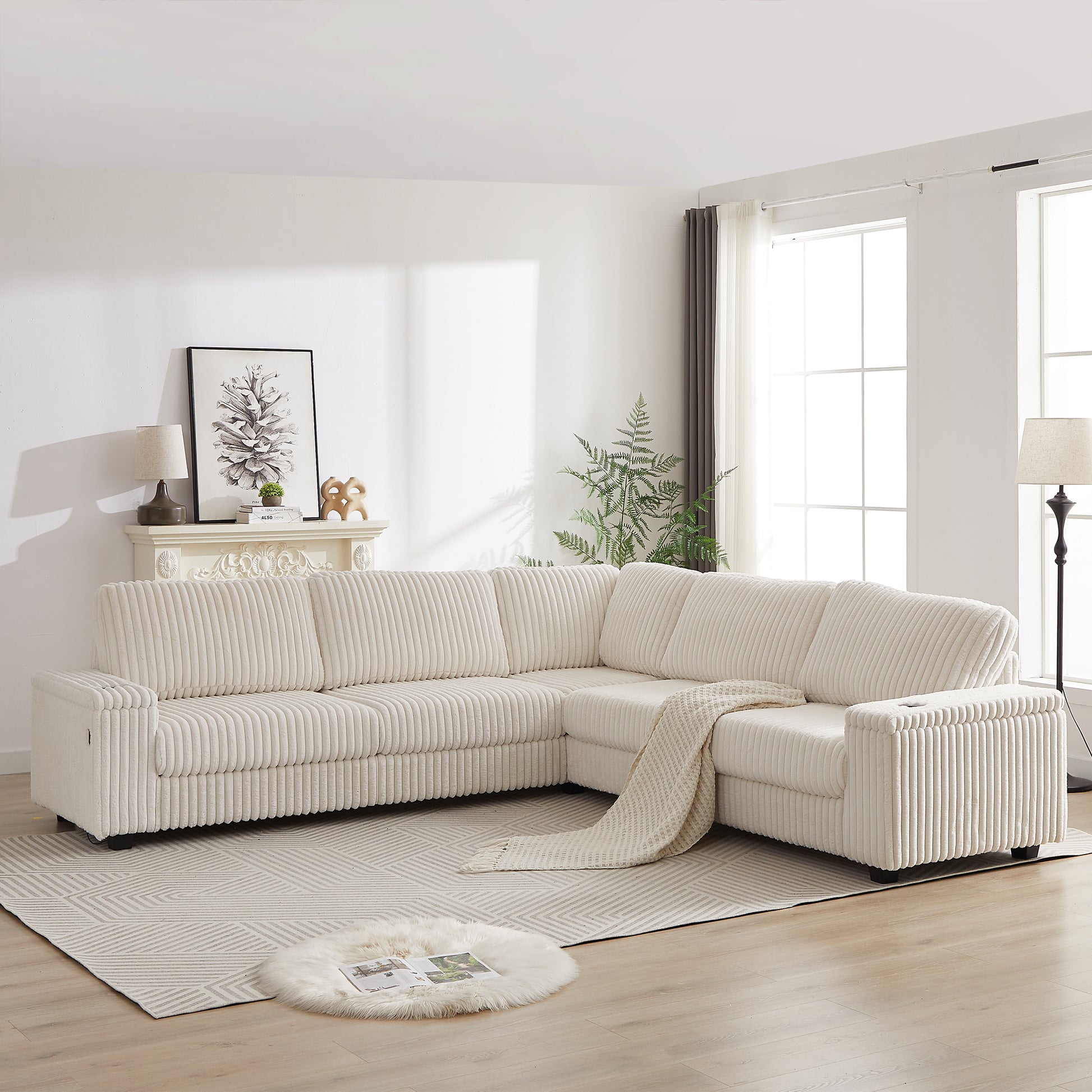 Cream corduroy sectional sofa with plush cushions and a woven throw blanket