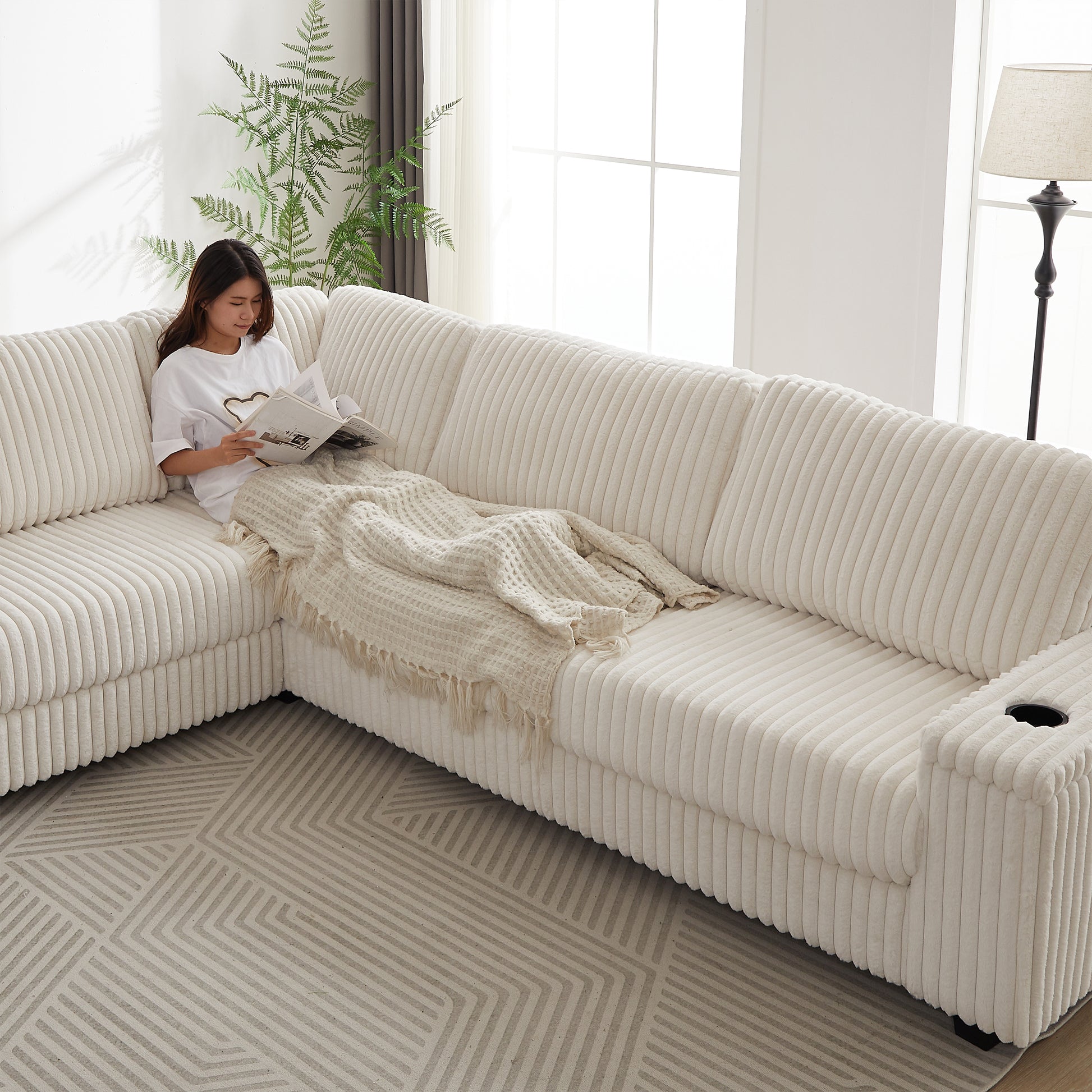 Plush cream corduroy sectional sofa with builtin cup holder for comfortable living room seating