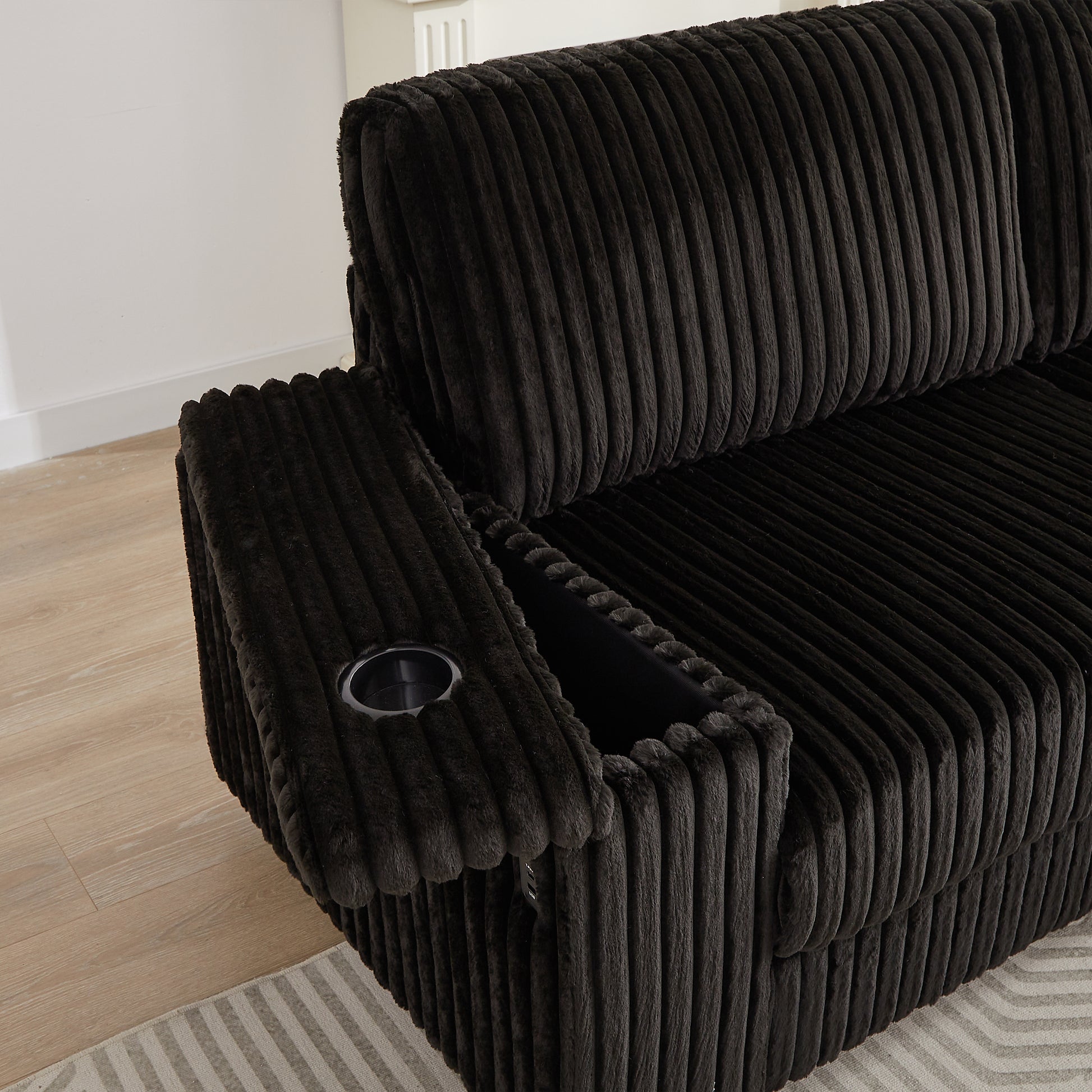Dark gray corduroy recliner with builtin cup holder and armrest storage