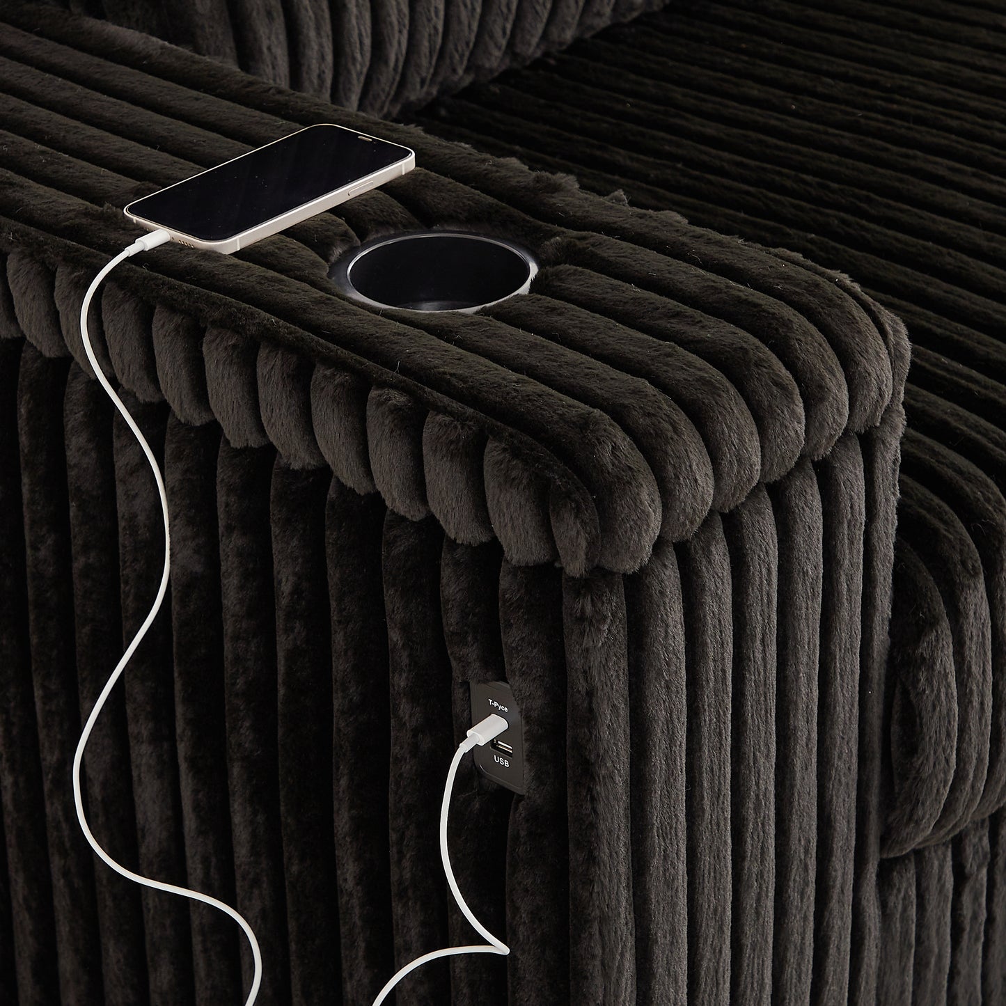 Dark gray corduroy armchair with builtin USB charging ports and a cupholder