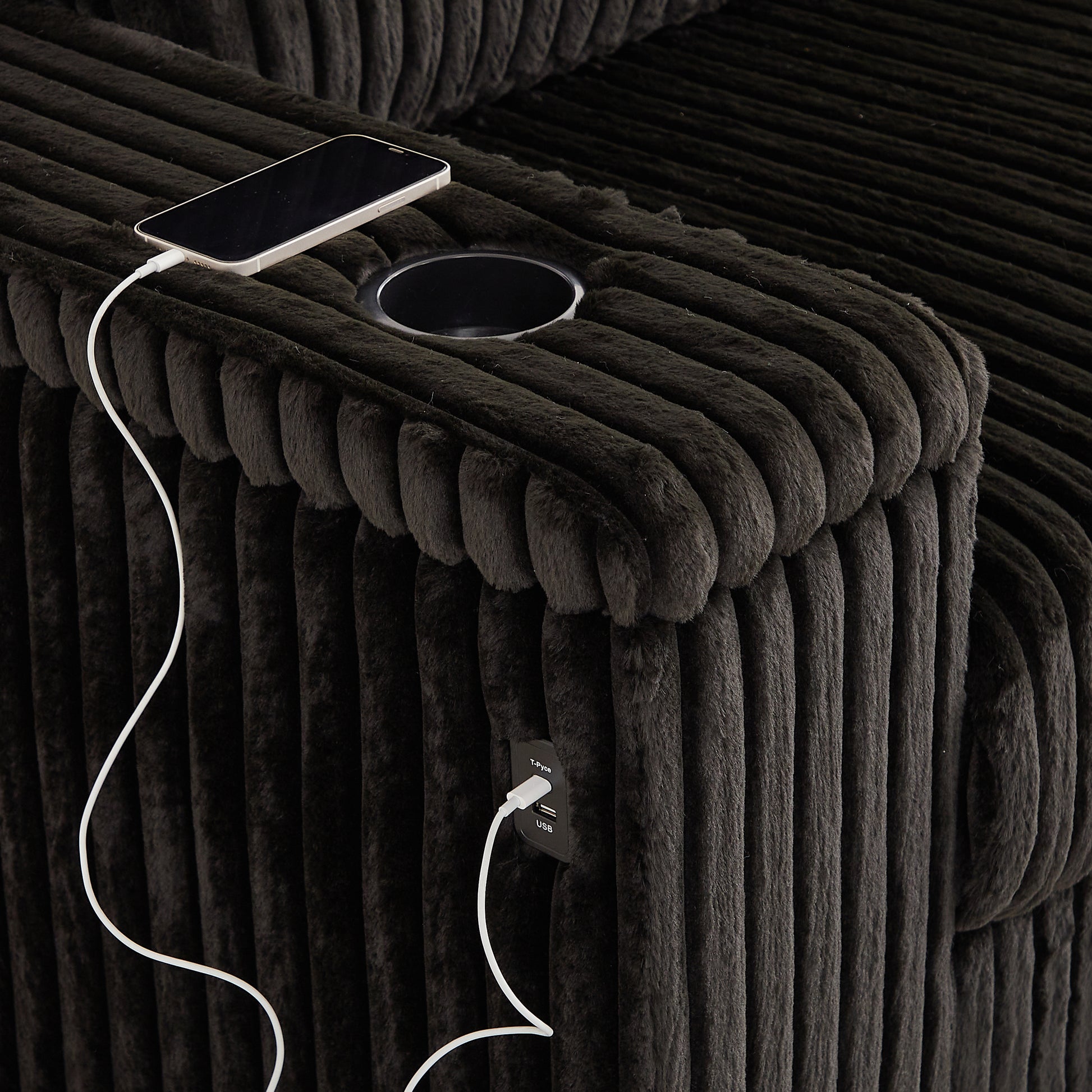 Dark gray corduroy armchair with builtin USB charging ports and a cupholder