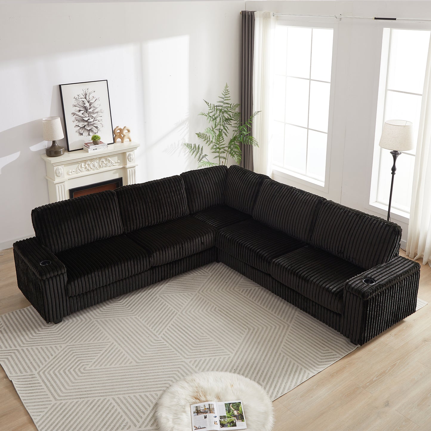 Black corduroy sectional sofa with plush cushions and builtin cup holders